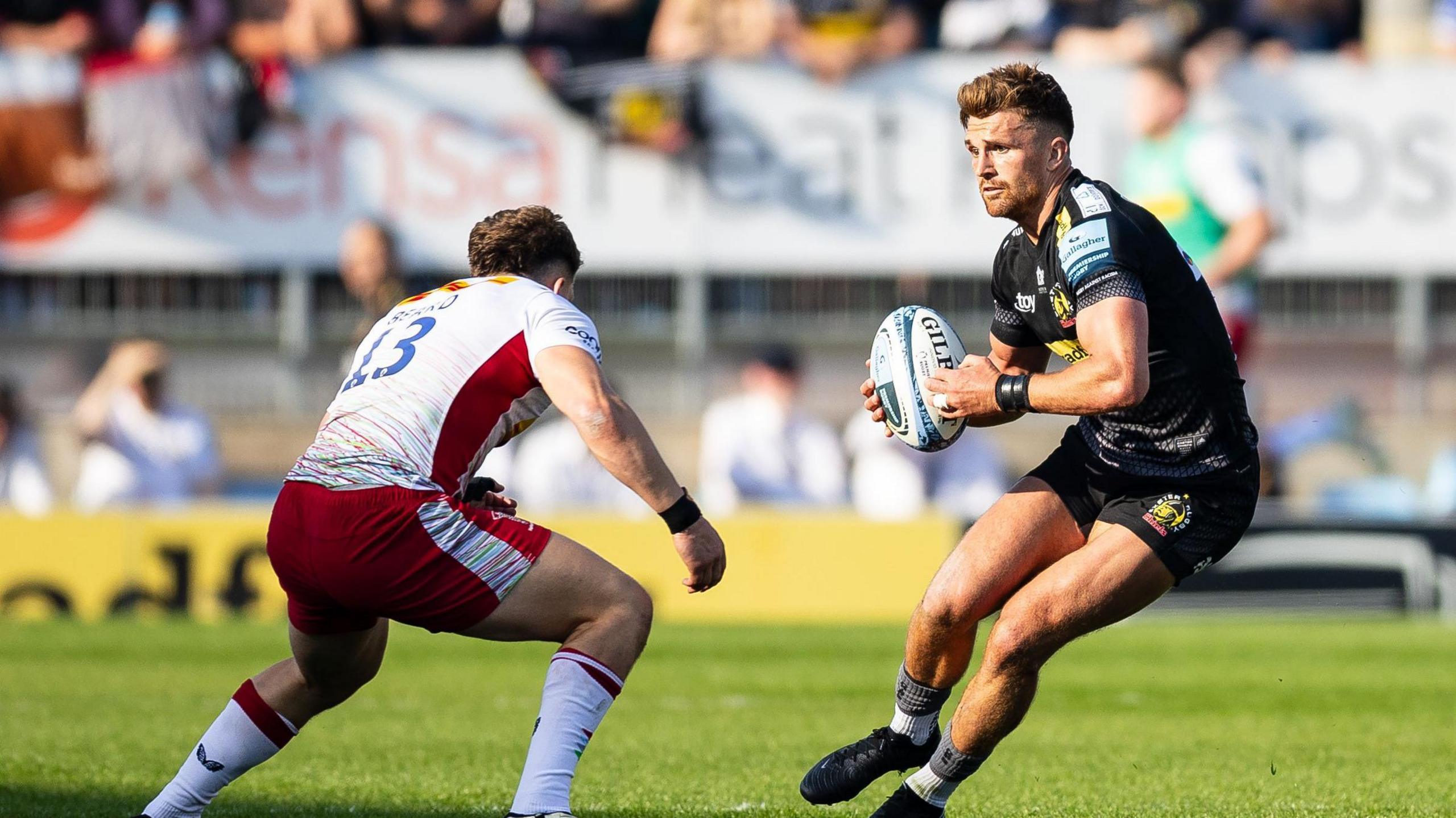 Henry Slade (right) avoids a tackle with the ball 