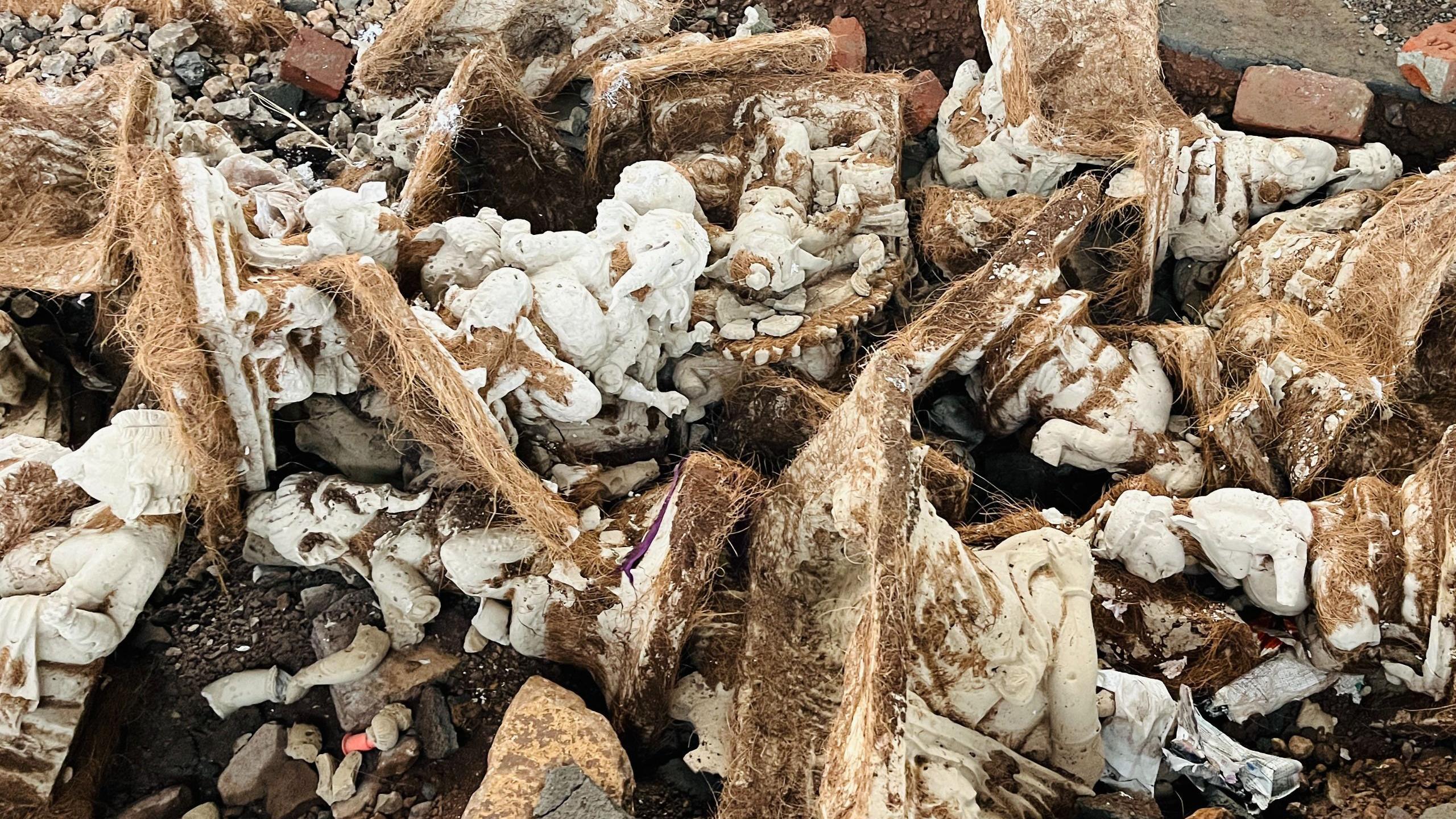 Ganpati idols destroyed due to heavy rain lie on the ground