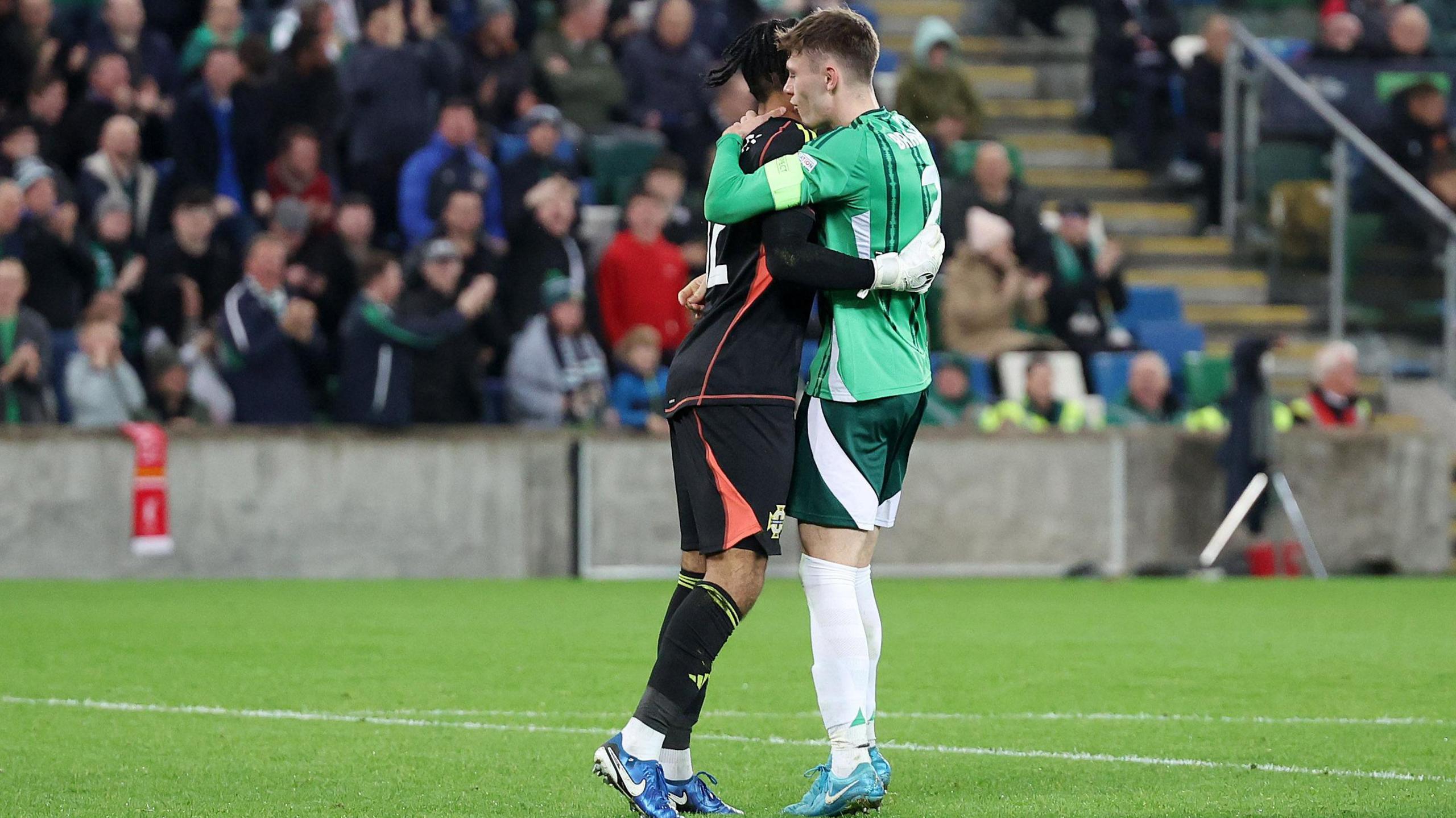 Pierce Charles and Conor Bradley celebrate after Bulgaria miss a penalty