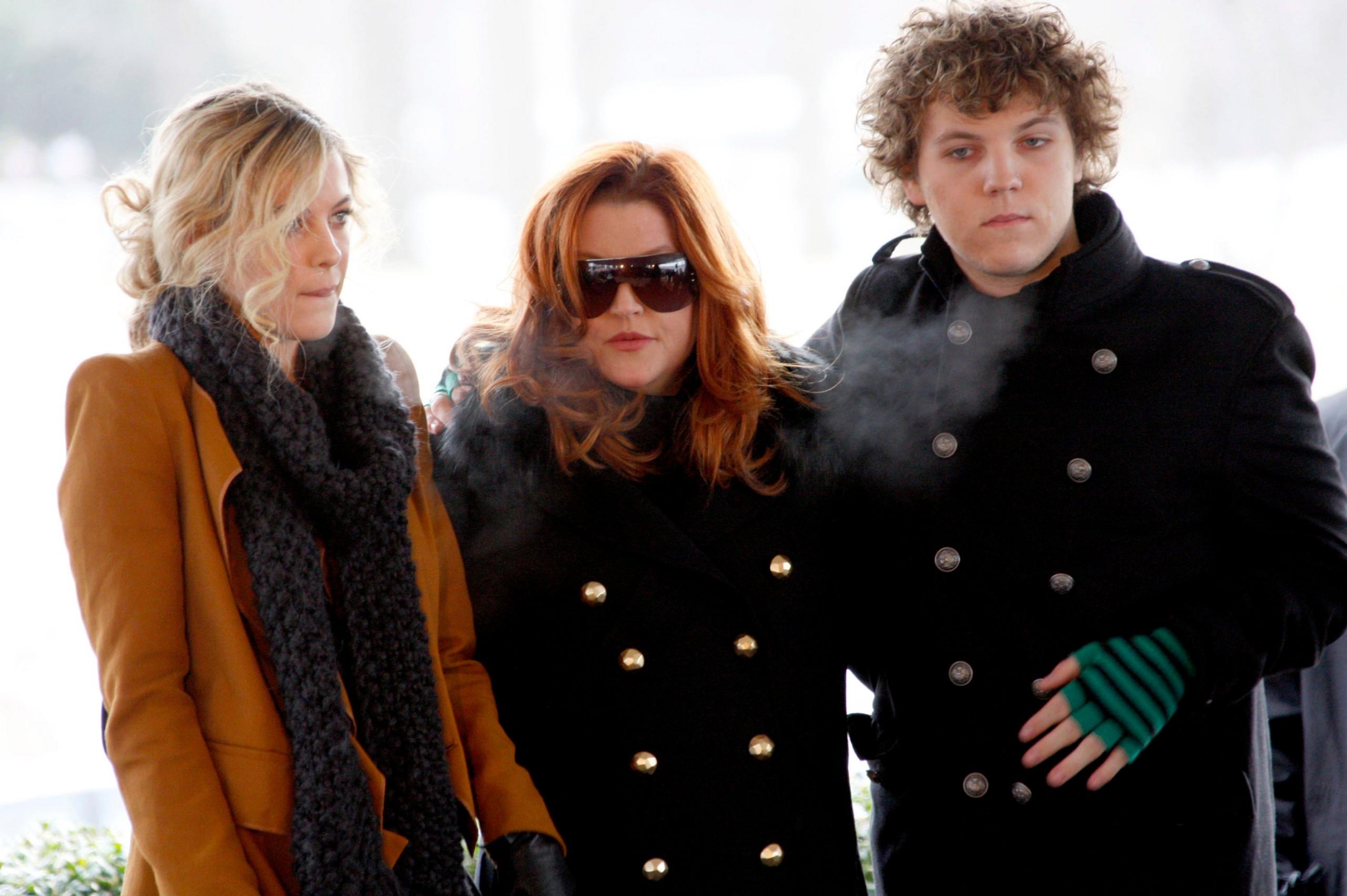 Lisa Marie Presley with her children Riley (L) and Benjamin Keough (R) at the 75th birthday celebration for Elvis Presley in Memphis, Tennessee January 2010