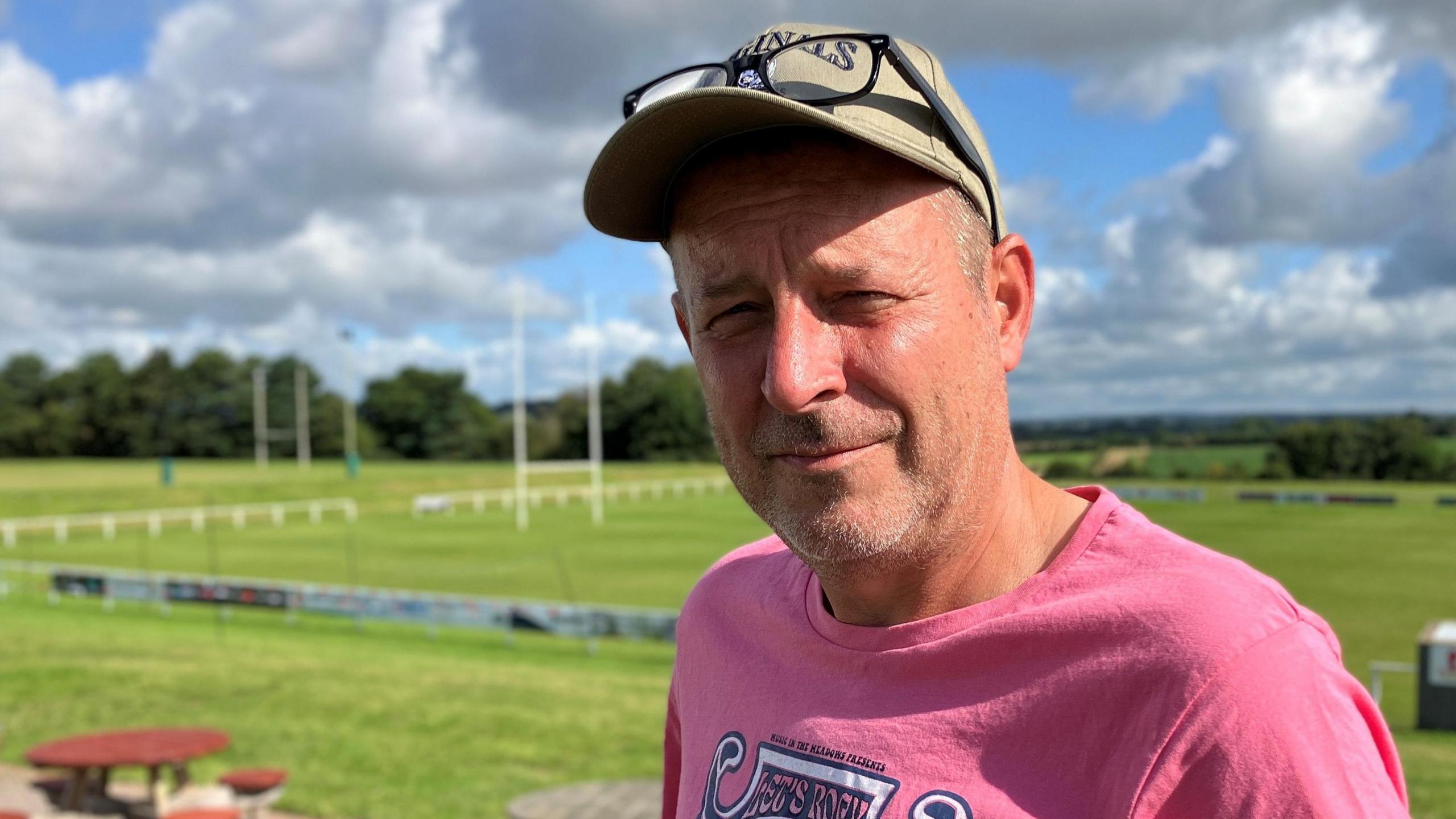 Man standing in front of rugby pitches