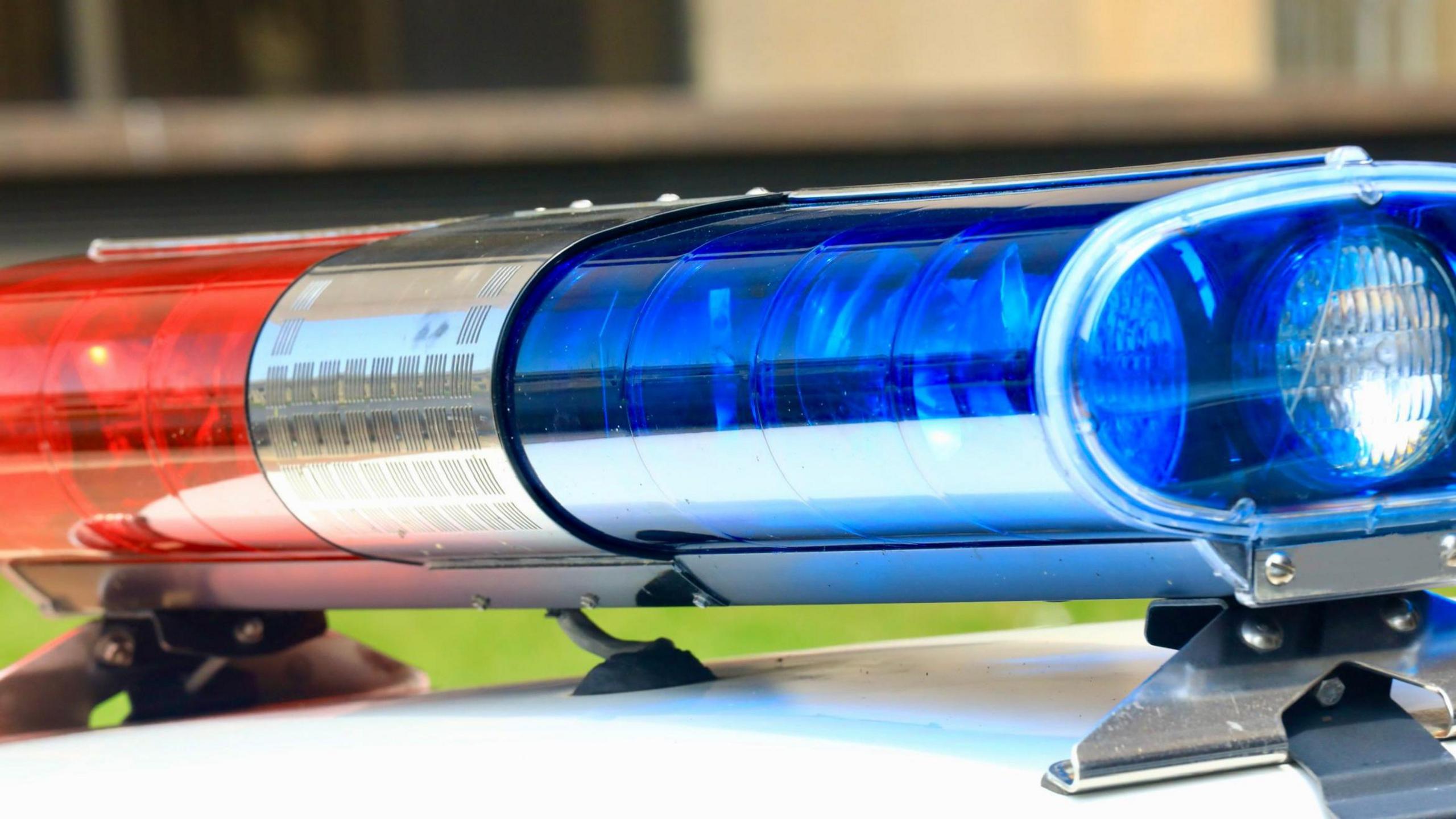 Blue and red lights on top of a police car.