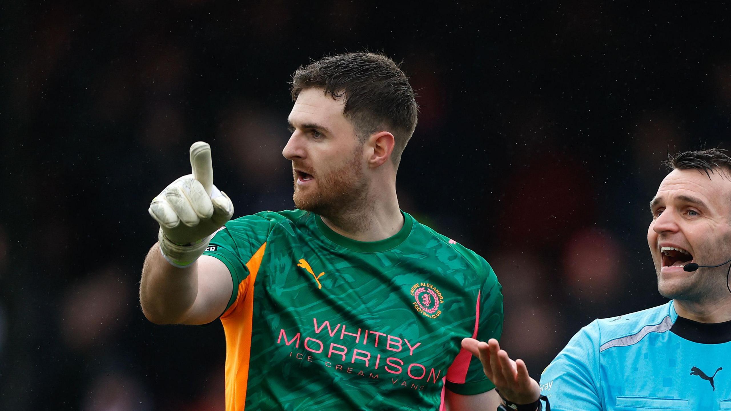 Crewe goalkeeper Ian Lawlor exchanges a few words with referee Benjamin Speedie during the trip to Crawley in Feburary