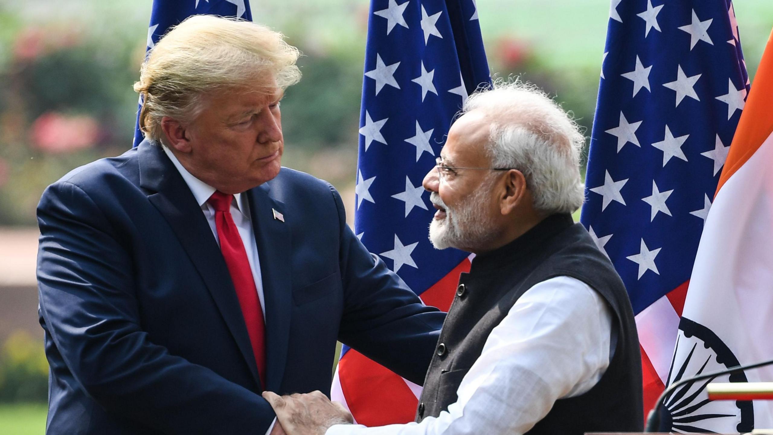 Donald Trump (left) shakes hands with Indian Prime Minister Narendra Modi