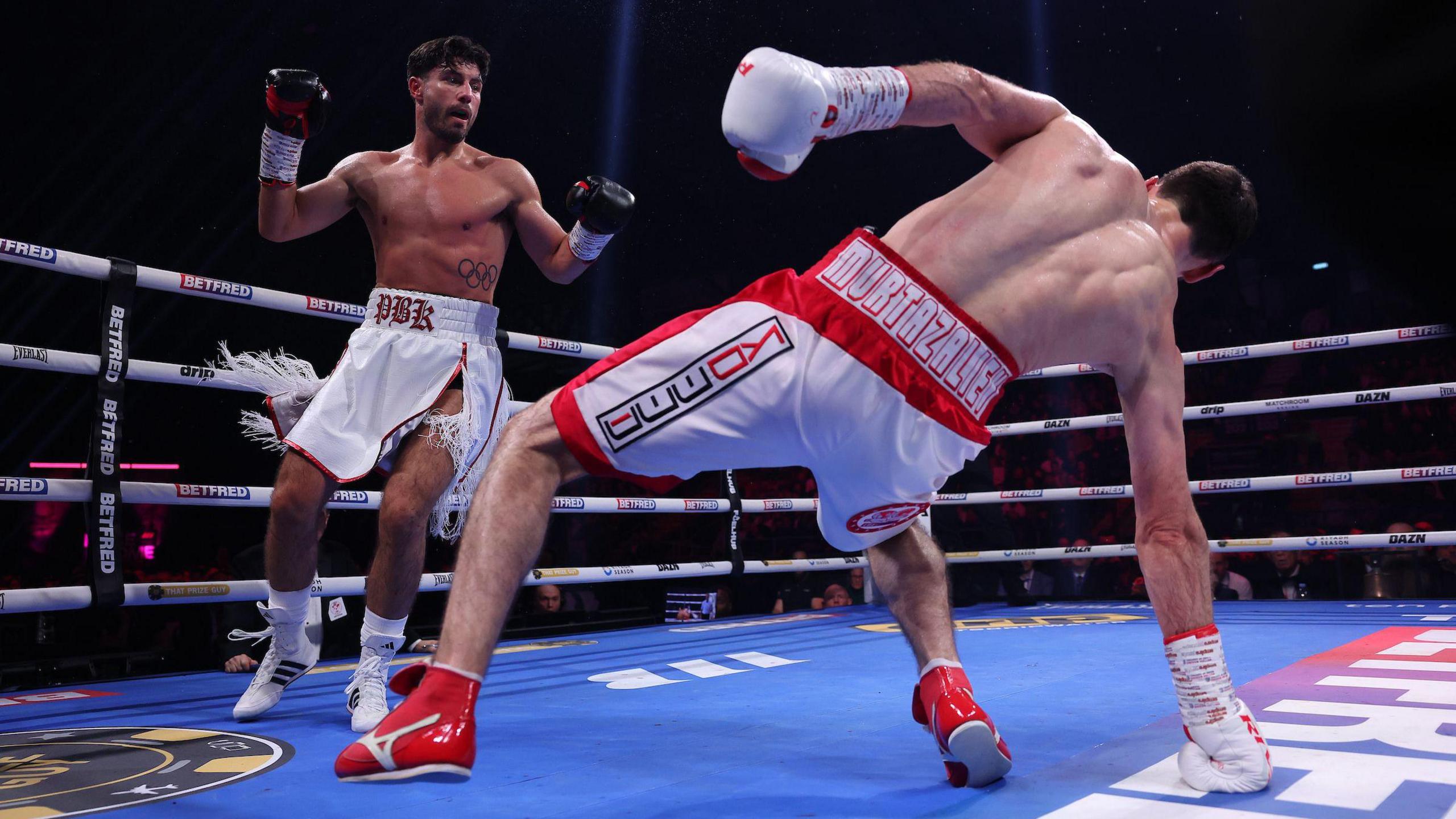 Josh Kelly looks on as Bakhram Murtazaliev touches the canvas