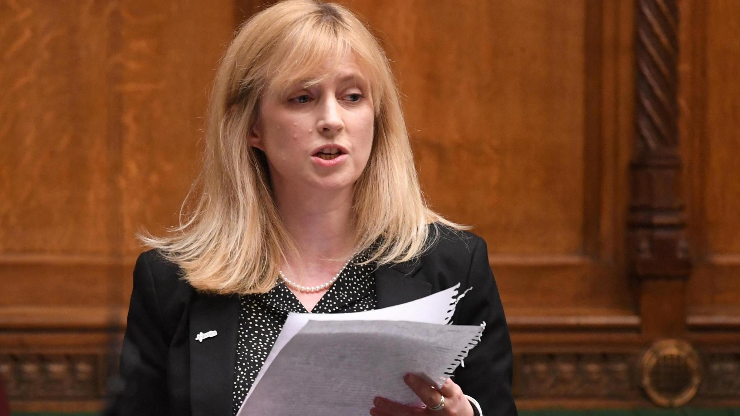 Member of Parliament (MP) Rosie Duffield delivers a speech during a session at Westminster. She is holding a sheet of paper.