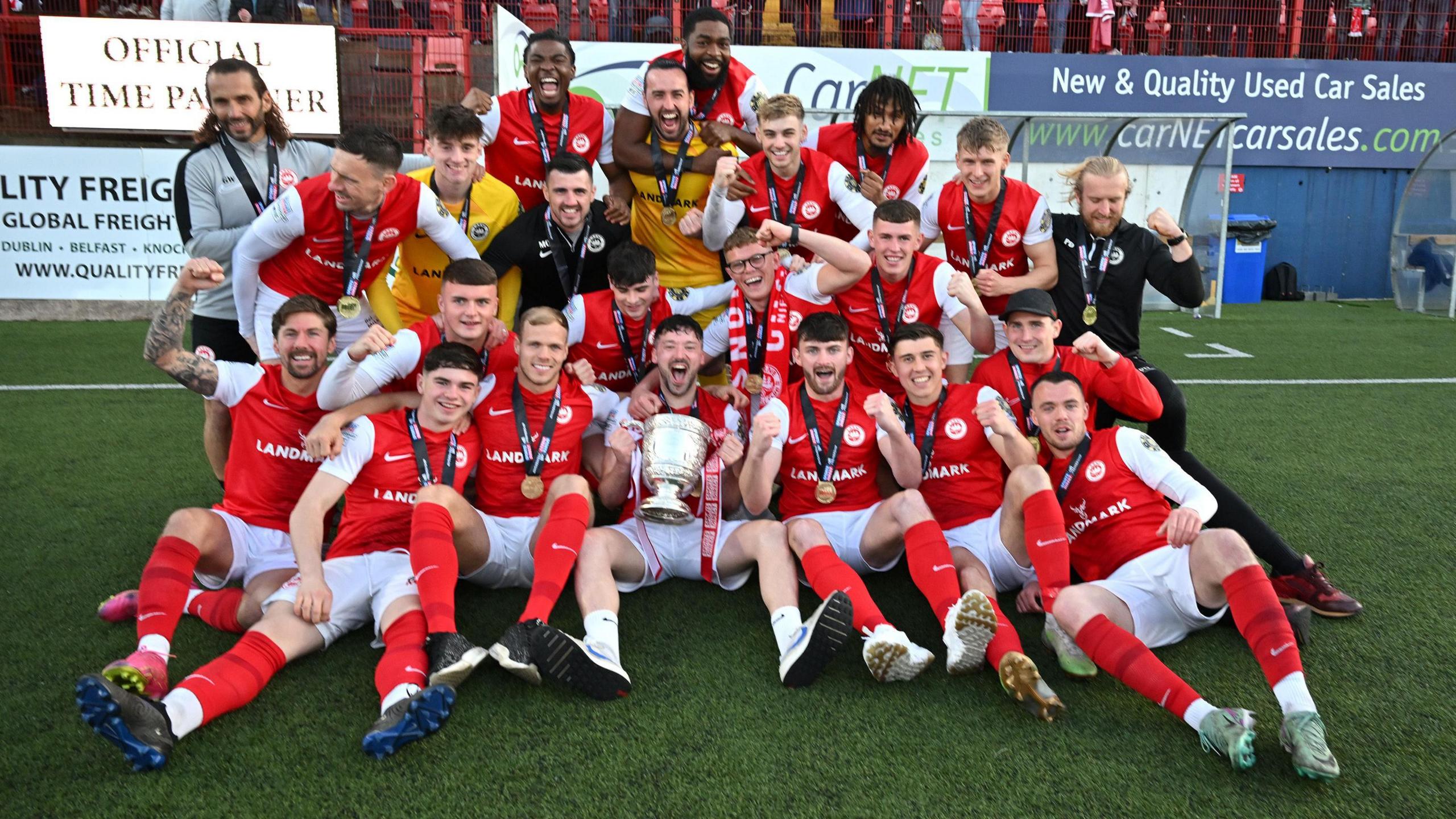 Larne players celebrate with the Gibson Cup