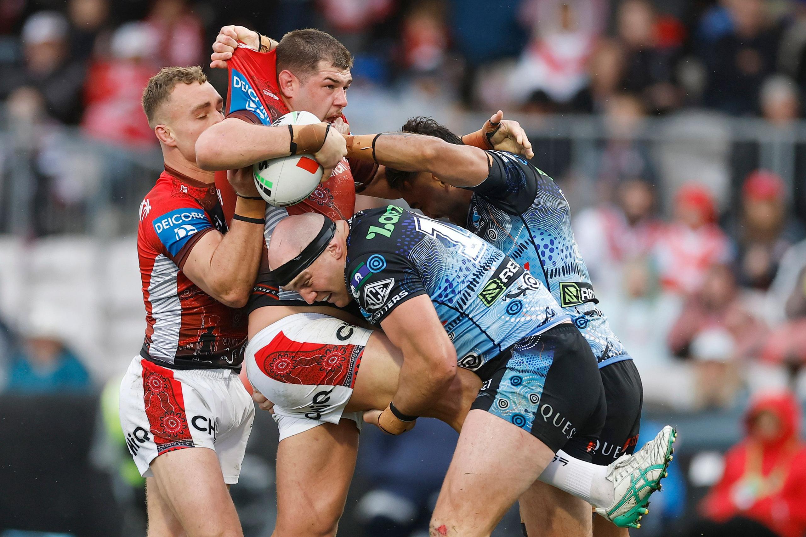 The Dragons' Blake Lawrie is tackled during a match between St George Illawarra Dragons and Cronulla Sharks at Netstrata Jubilee Stadium in Sydney, Australia. Photo by Darrian Traynor