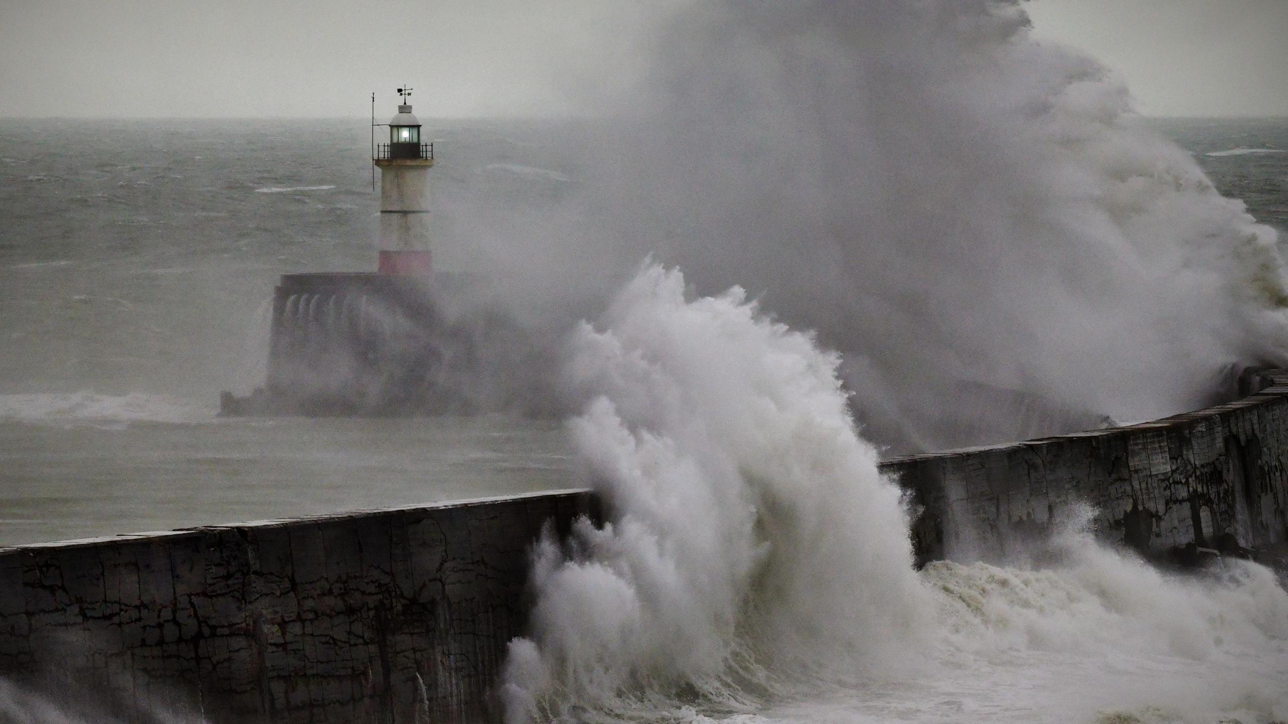 The lighthouse at the end of the westside breakwater at Newhaven Harbour, East Sussex, pictured during a summer gale and high tide in 2019