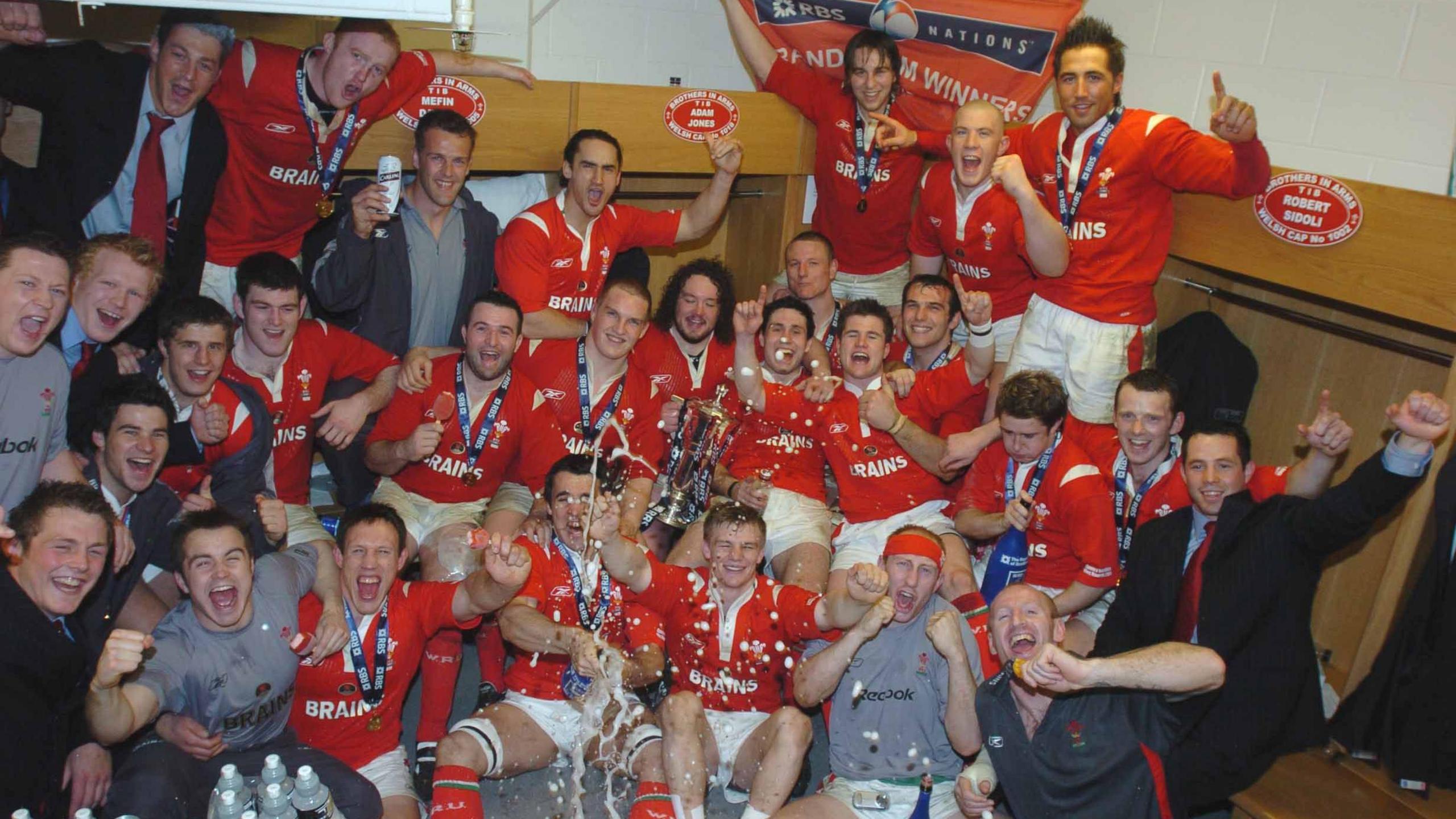 Wales players celebrate winning the Six Nations inside their changing room