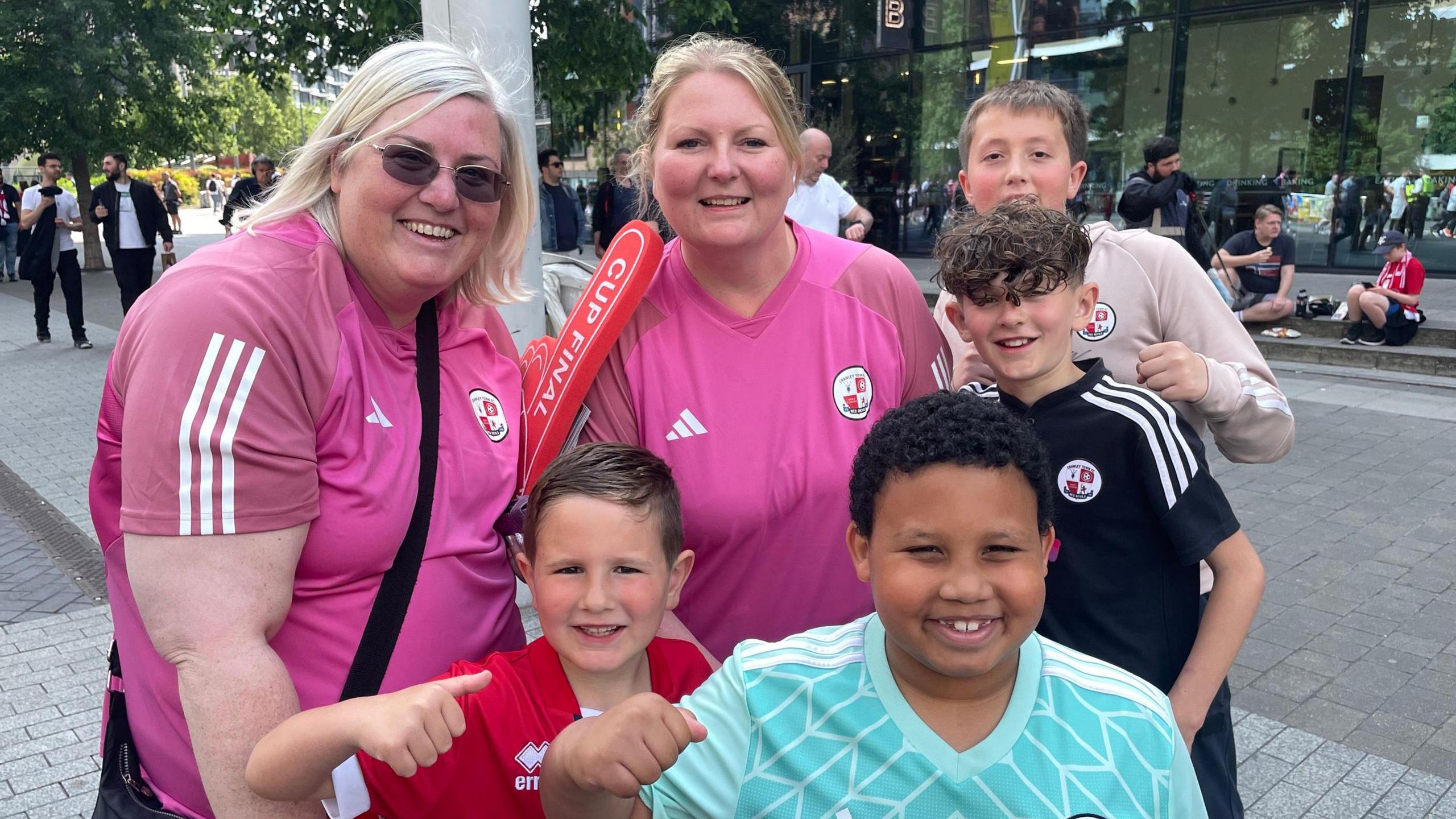 Six people all smiling on Wembley Way