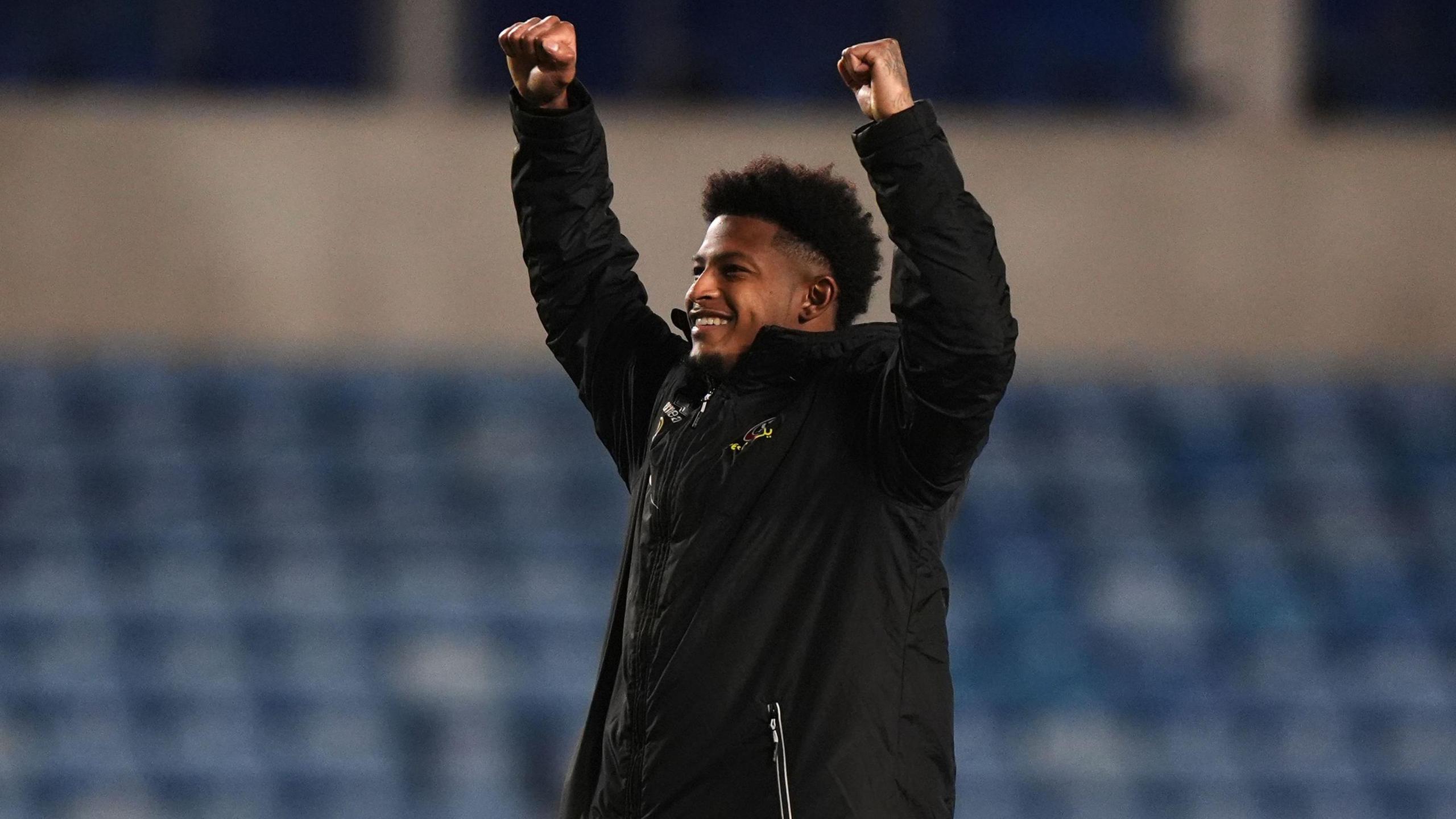 Rhian Brewster celebrates with his arms aloft in front of the travelling Sheffield United fans