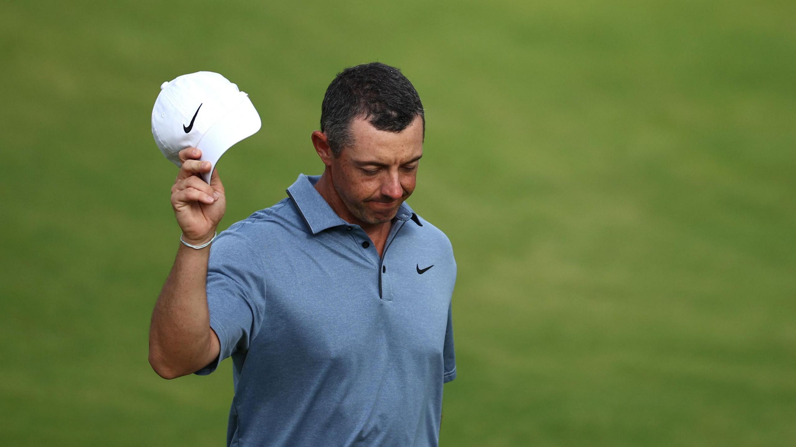 Rory McIlroy acknowledges the crowd while walking to the final green on Sunday