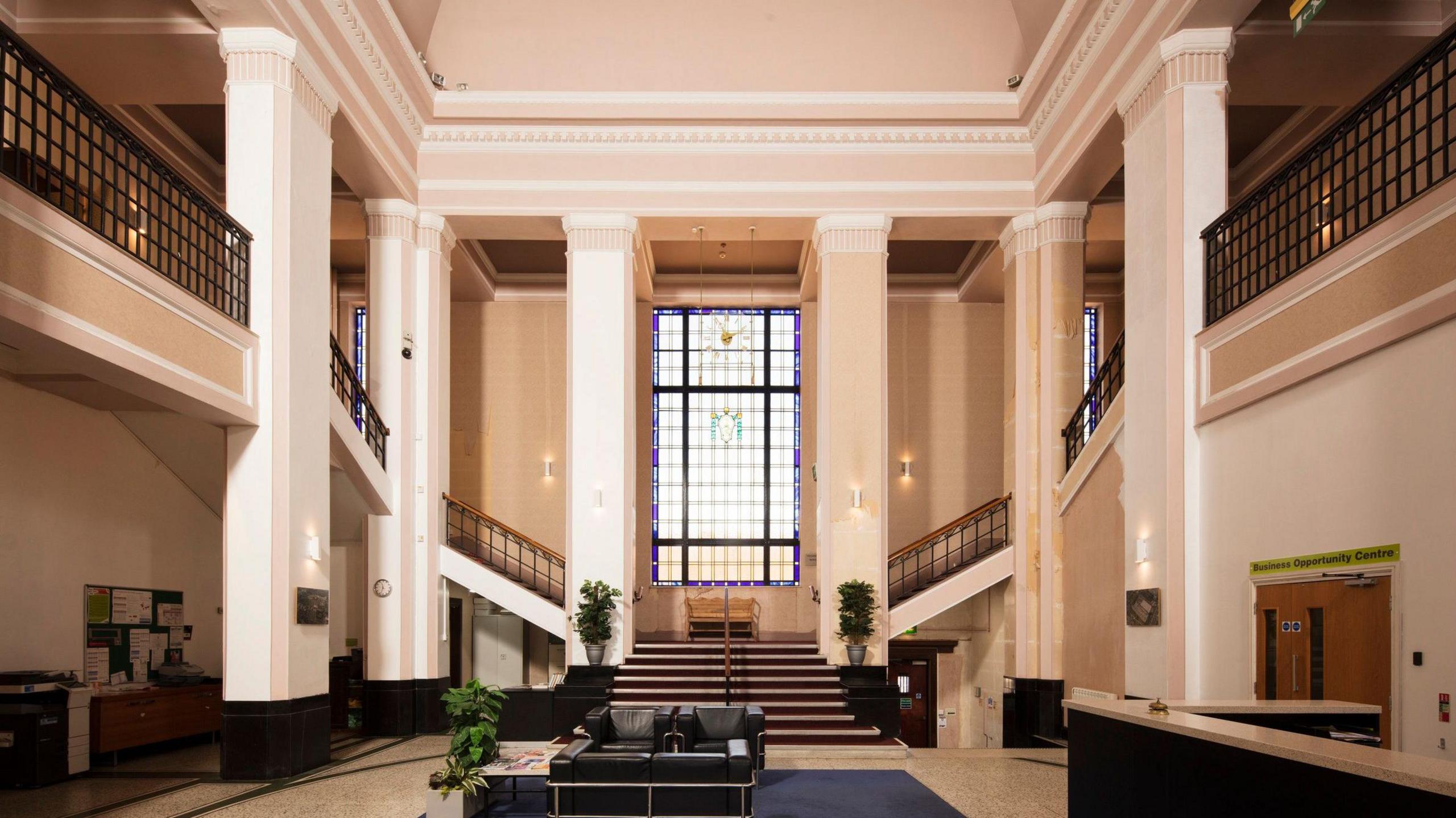 Entrance Hall of the Howitt Building, showing a high ceilinged room with a grand staircase