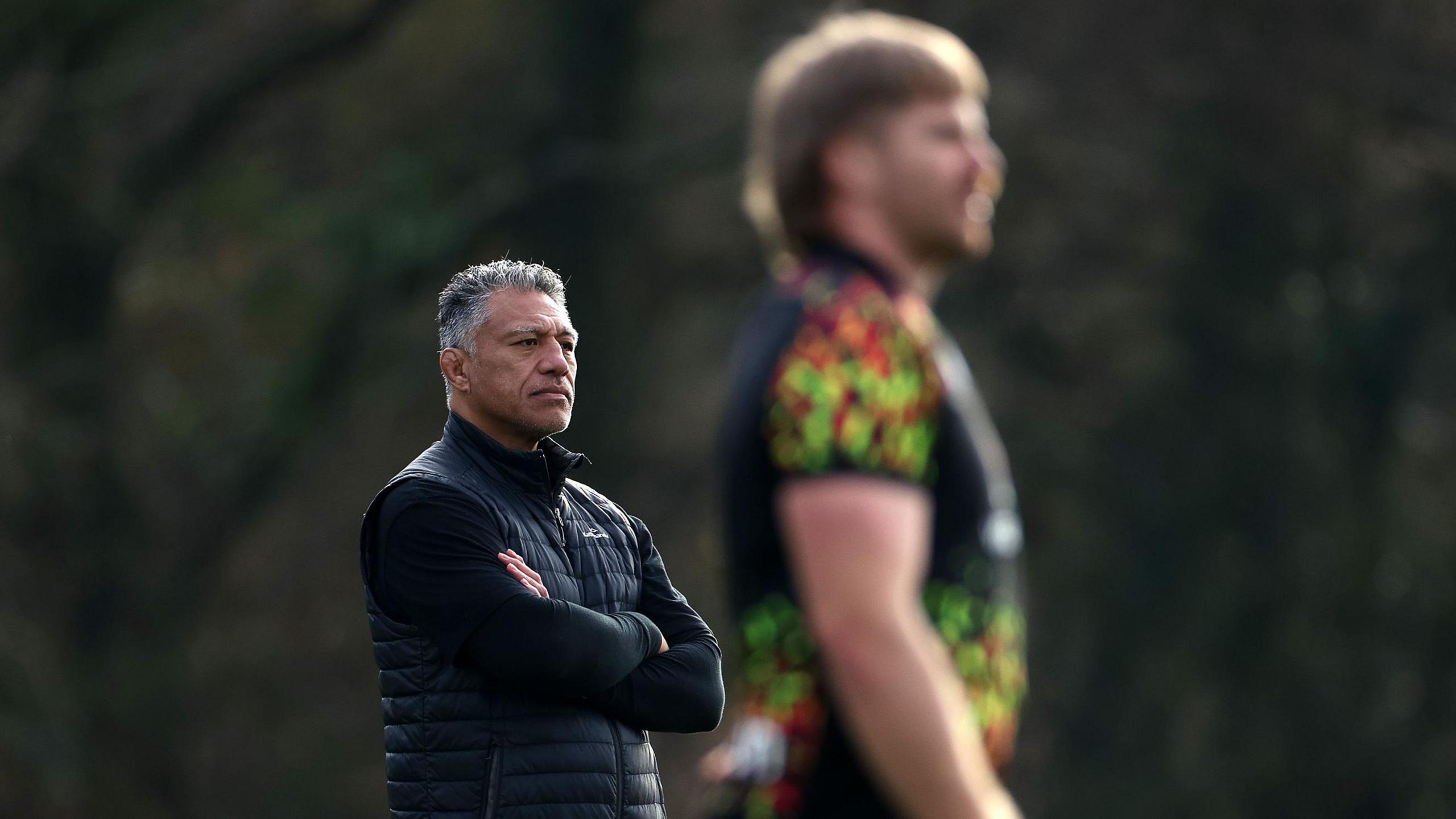 Dragons head coach Filo Tiatia watches Wales training with Aaron Wainwright in the foreground