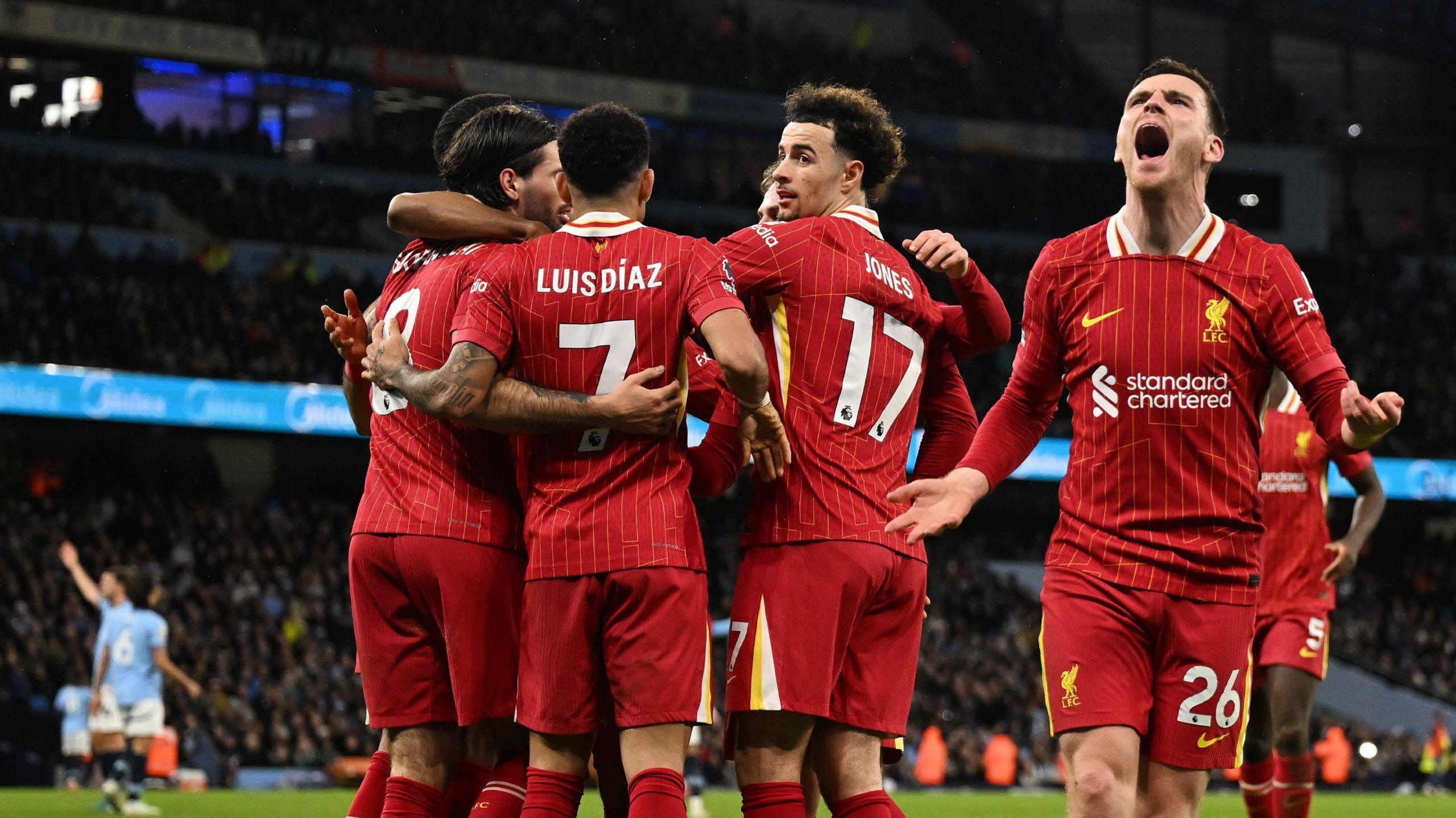 Liverpool players celebrate the win at Manchester City that points them 11 points clear of Arsenal at the top of the Premier League