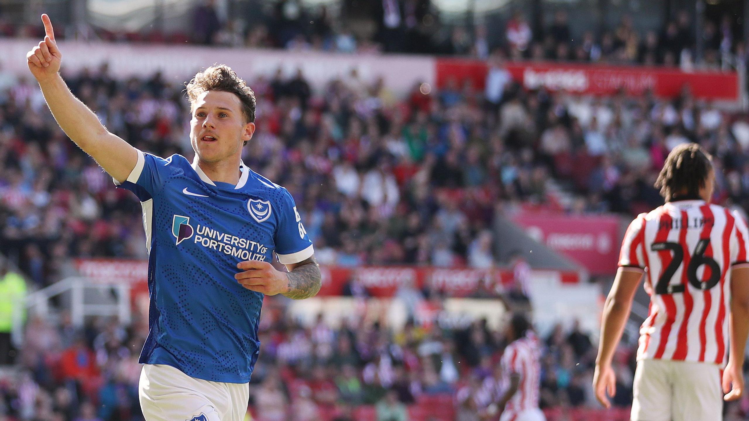 Portsmouth's Adrian Segecic has his right hand up as he celebrates scoring against Stoke