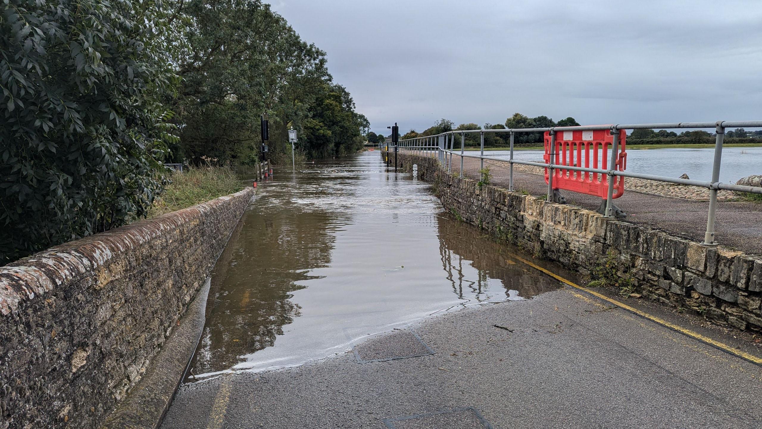 The bridge that accesses Harrold is submerged in water and appears completely impassable.