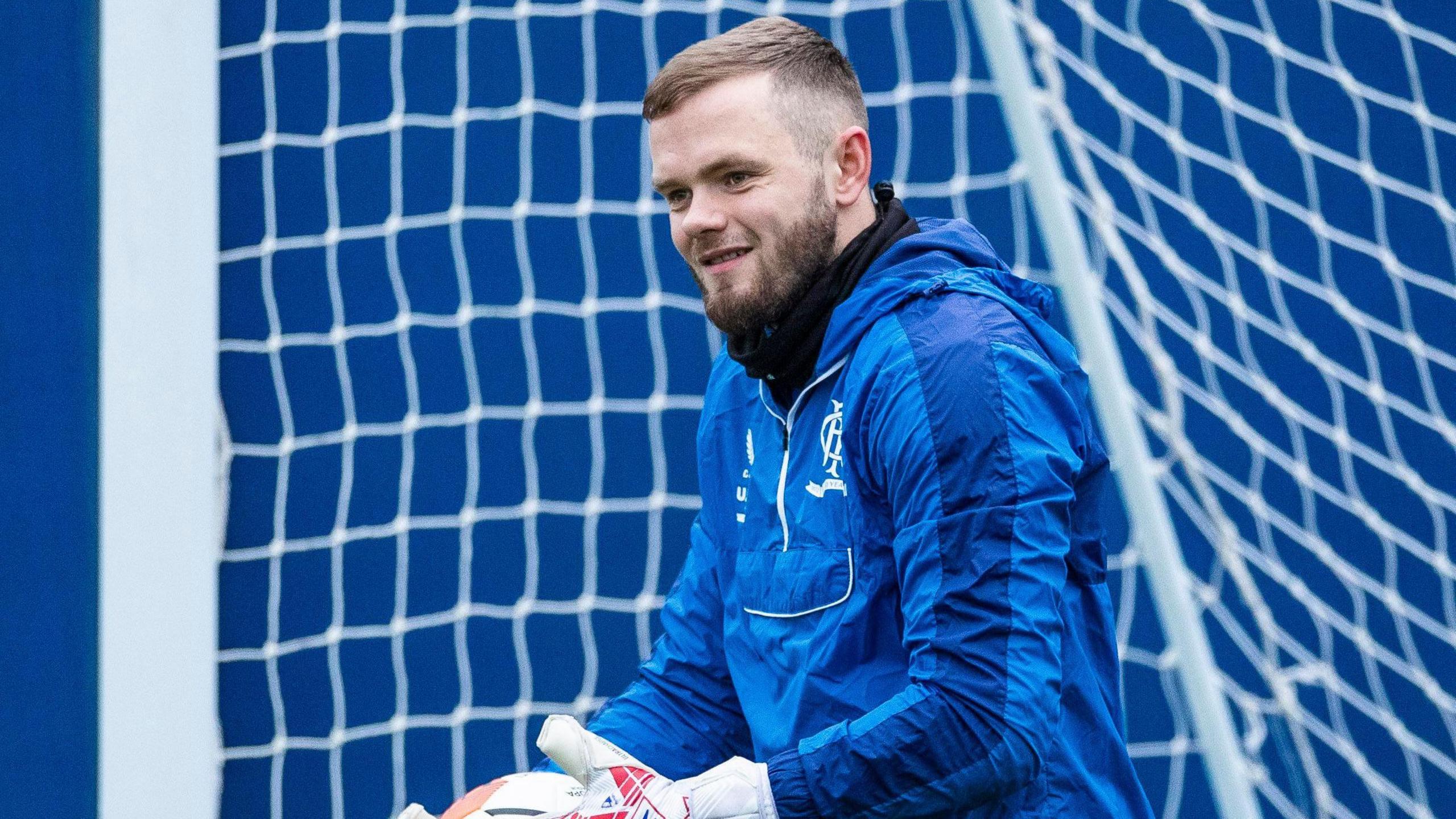 Goalkeeper Andy Firth pictured in training whilst with Rangers, dressed in blue training top and standing in front of the net.