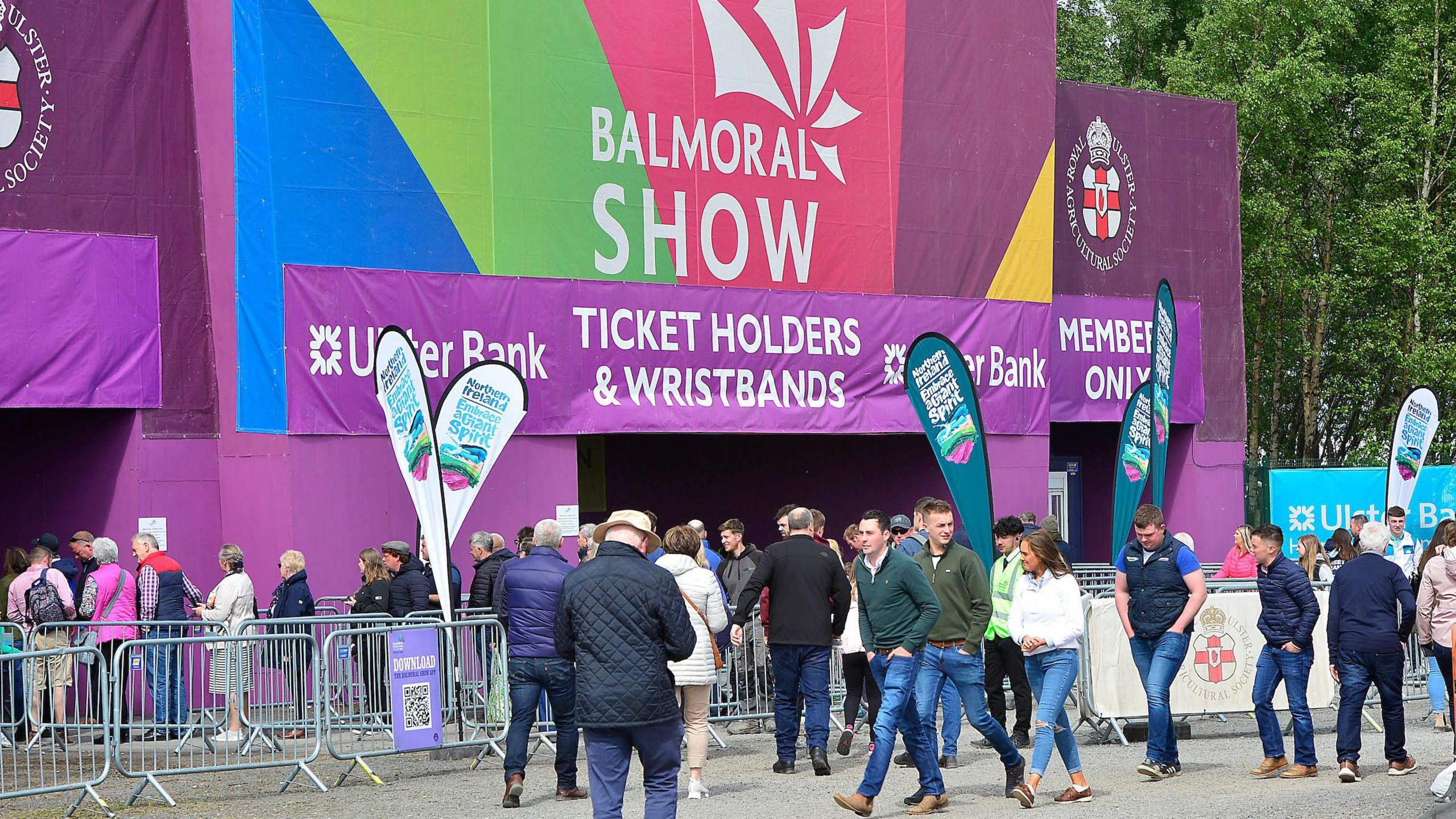 The entrance to the Balmoral Show - a large purple sign reads "Balmoral Show" and crowds of people can be seen queuing to enter.