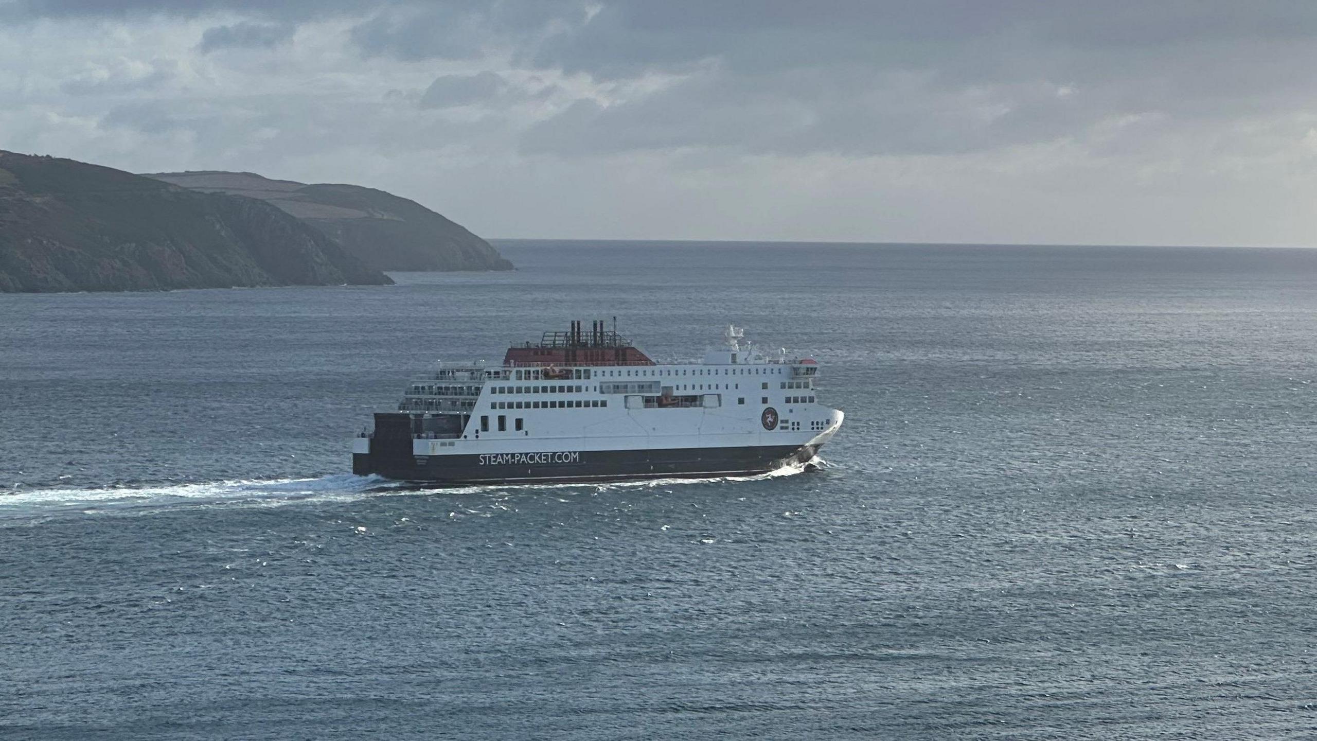 The Manxman ferry sailing away from Douglas Bay, with a headland in the background.