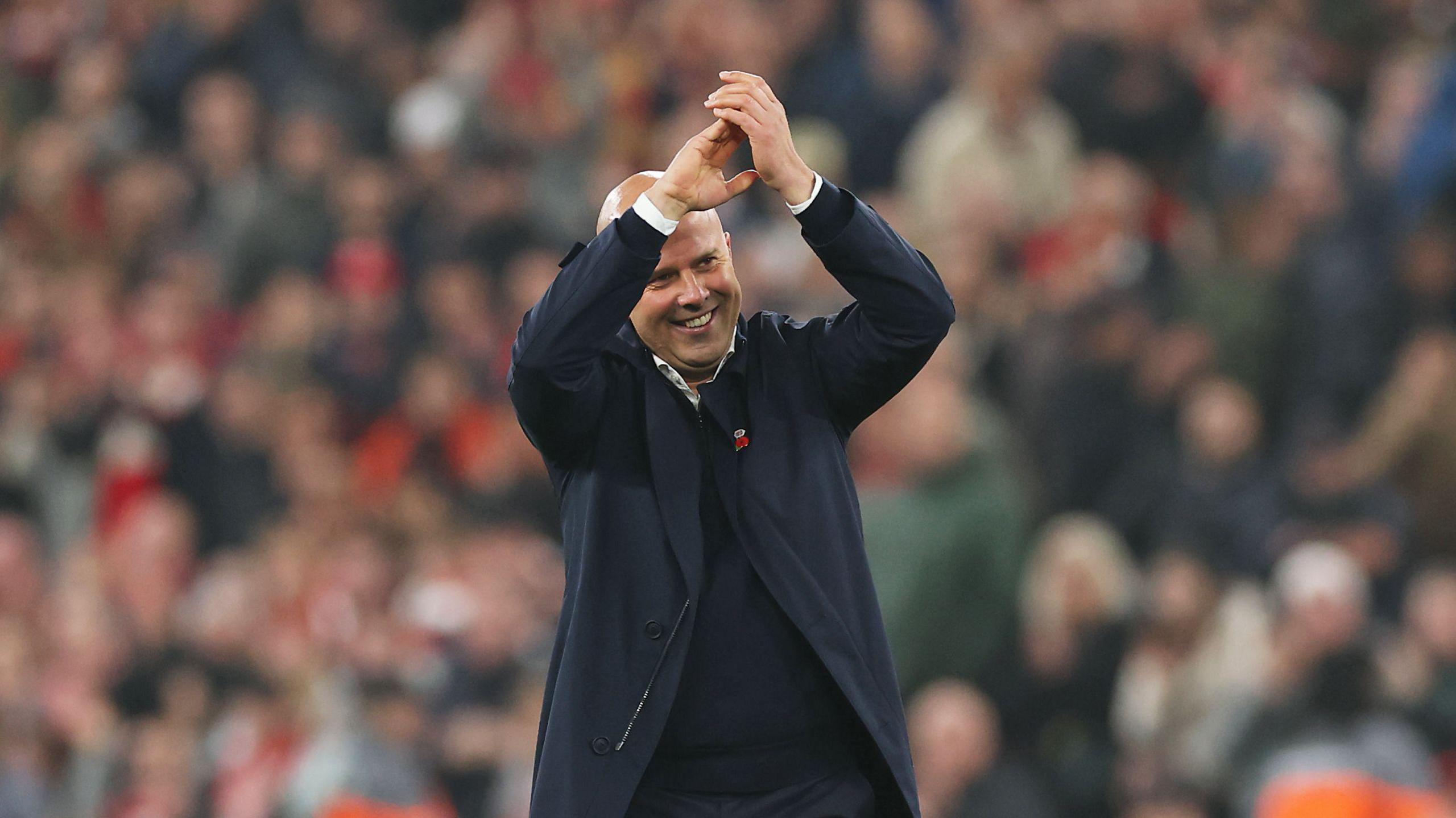 Arne Slot clapping towards Liverpool fans after his side's win over Aston Villa on Saturday