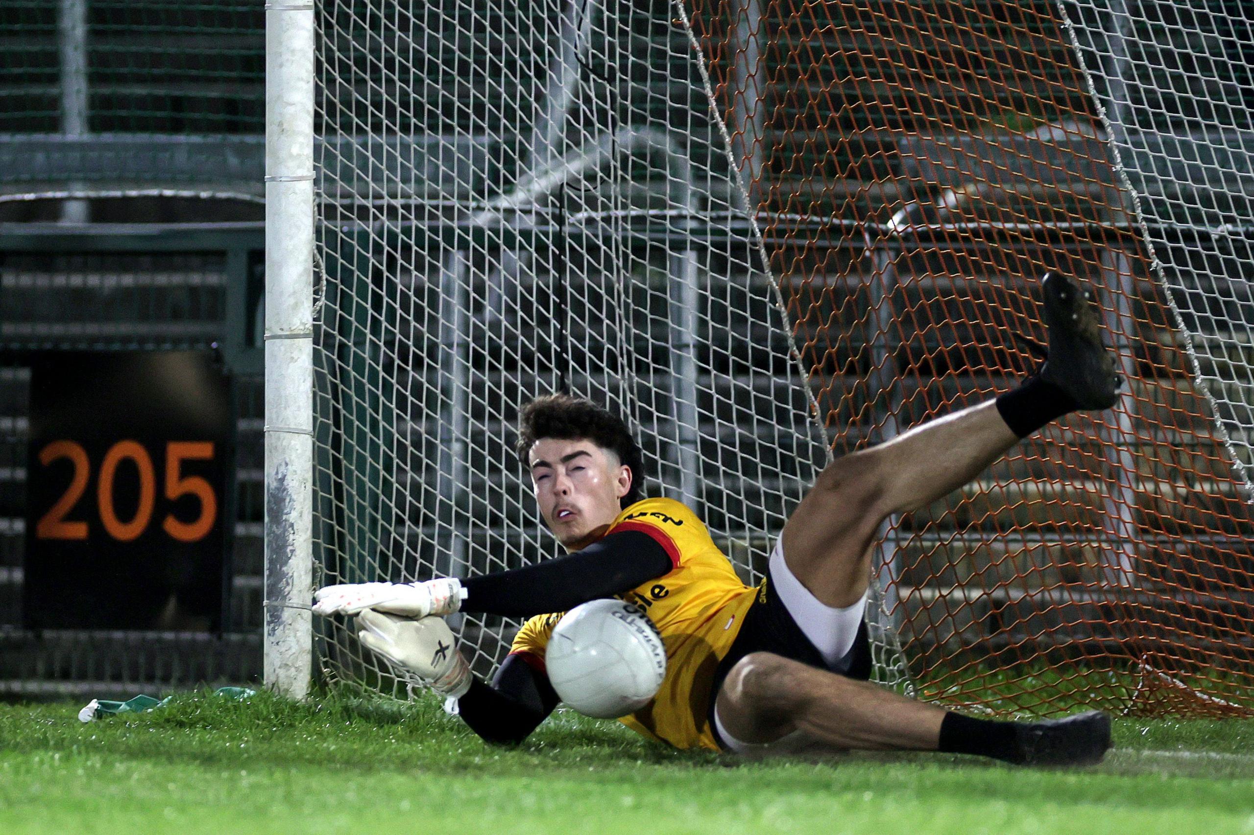 Conor McAneney saves a penalty