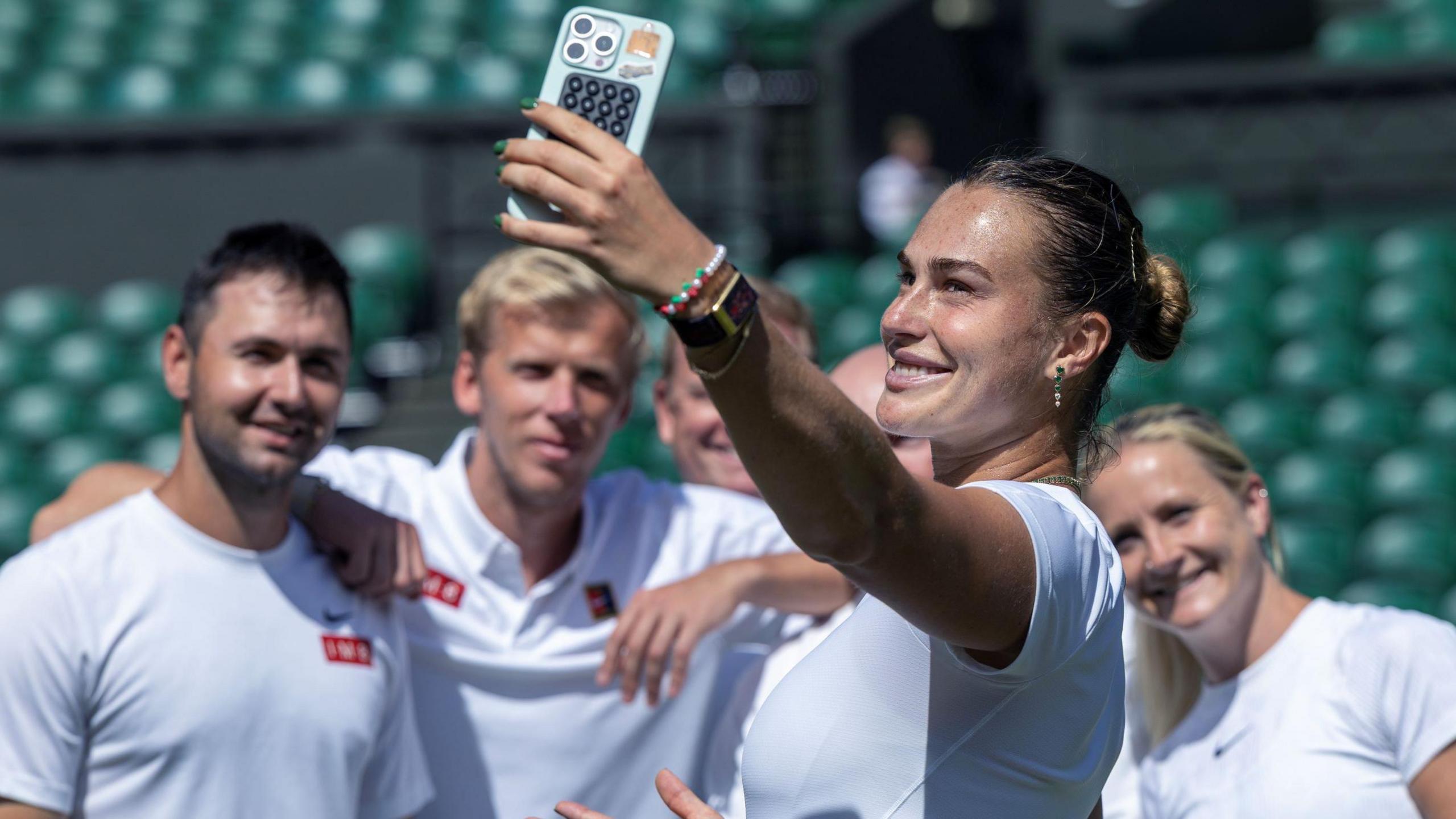 Aryna Sabalenka takes a selfie with her team at Wimbledon