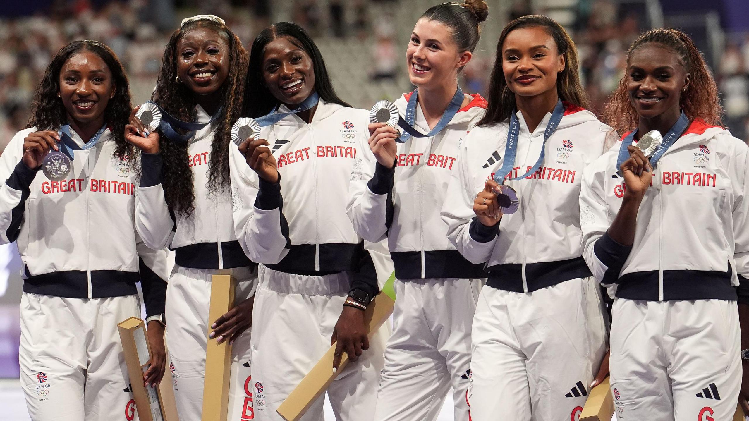 Great Britain's Amy Hunt, Dina Asher-Smith, Desiree Henry, Imani Lansiquot, Daryll Neita and Bianca Williams celebrate with their silver medals during the medal ceremony for the Women's 4 x 100m Relay Final