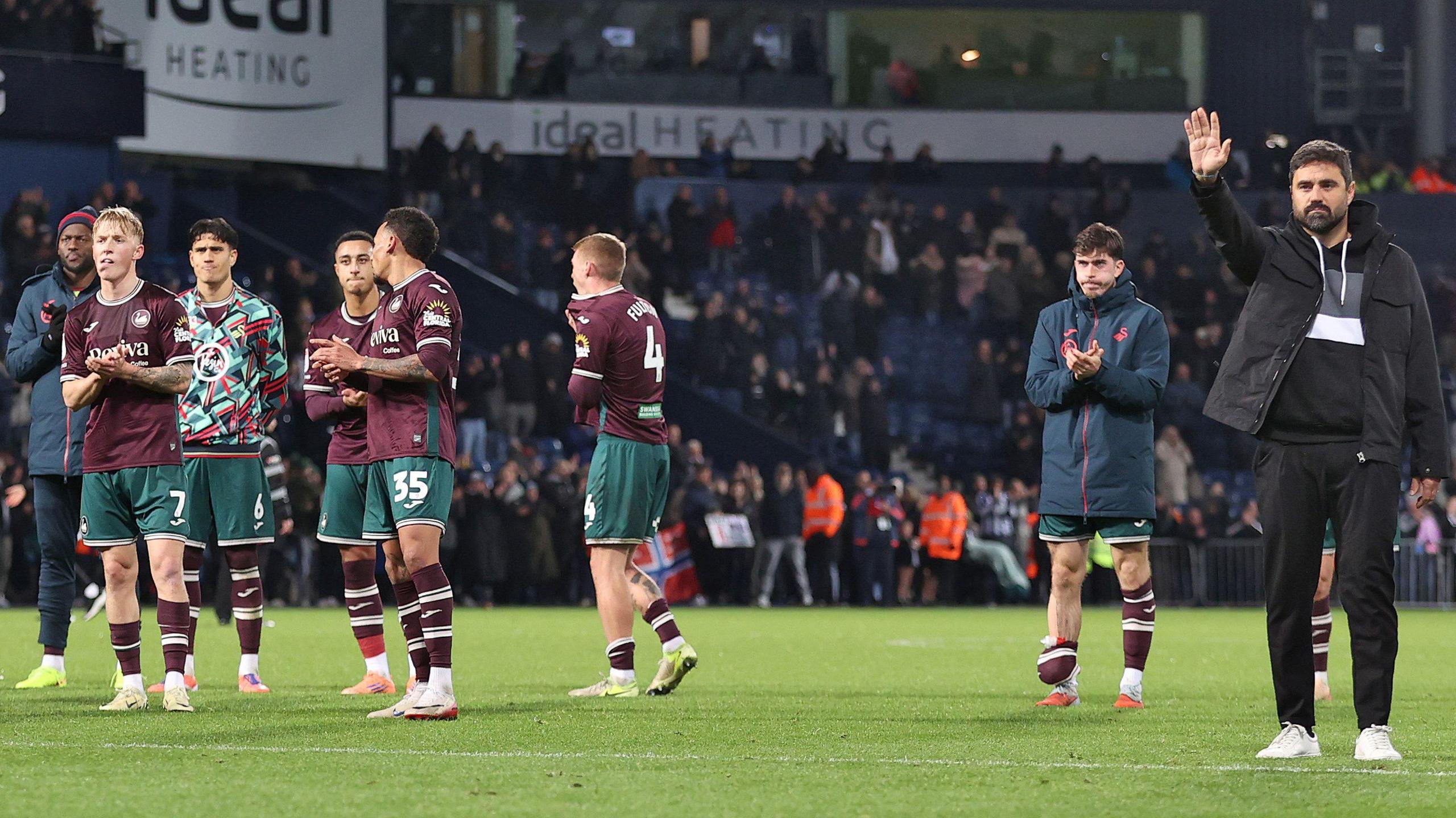 Swansea players and staff acknowledge their fans at West Brom
