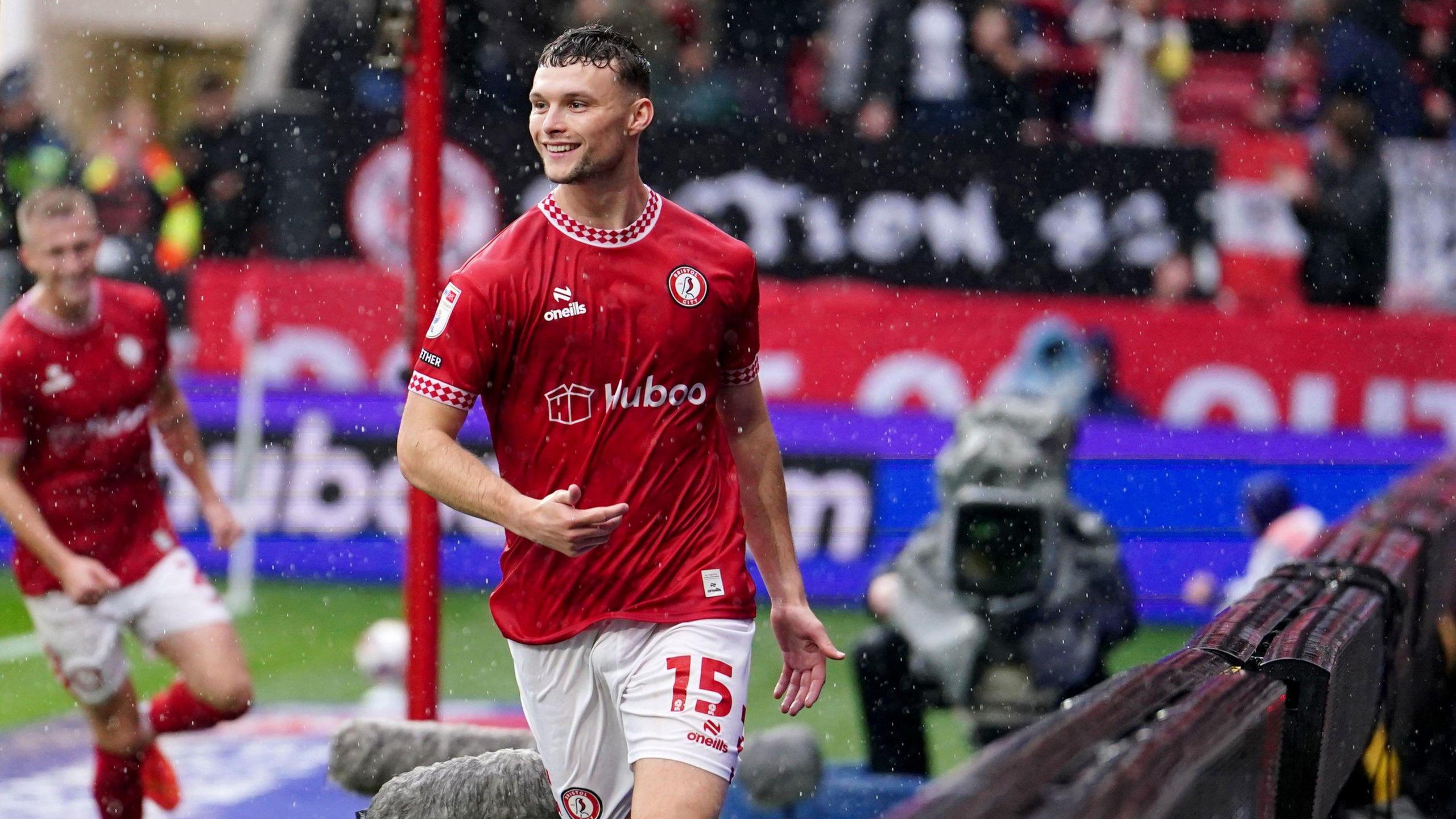 Bristol City's Luke McNally smiles as he celebrates scoring the equaliser against Cardiff City in the Severnside derby at Ashton Gate Stadium. McNally is running behind the goal and a team mate can be seen running to join him in the background