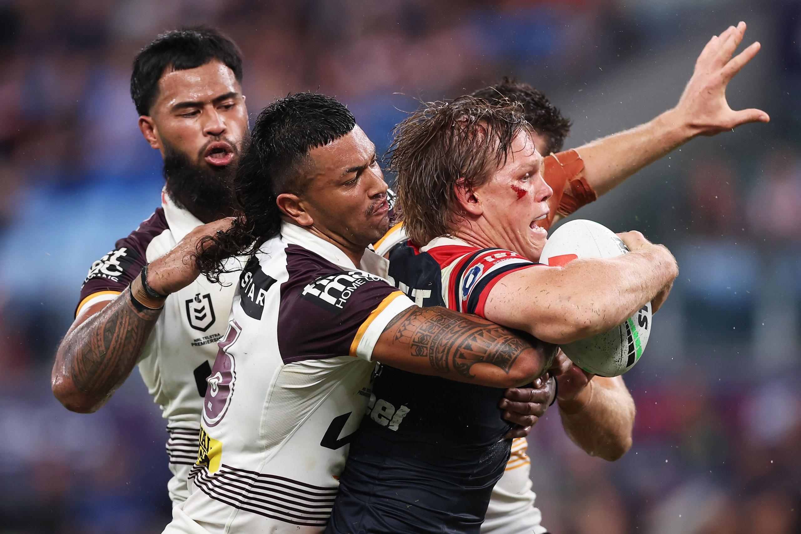 Sydney Roosters Lindsay Collins is tackled during the round one NRL match between and Brisbane Broncos at Allianz Stadium in Sydney, Australia