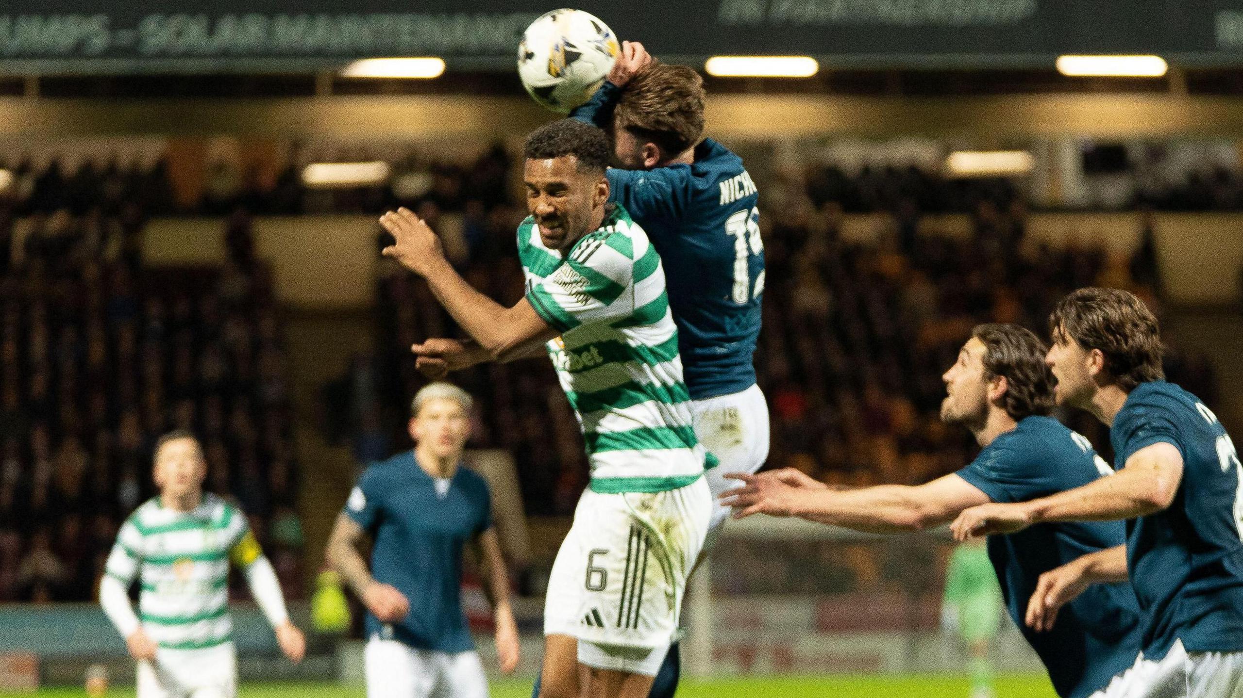 Motherwell's Sam Nicholson jumps with Celtic's Aaron Trusty