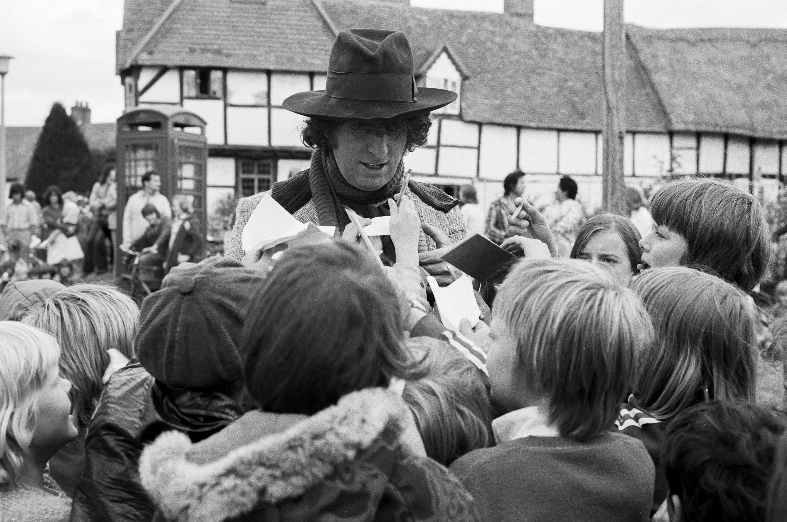 Tom Baker signing autographs for excited fans in 1975 during film