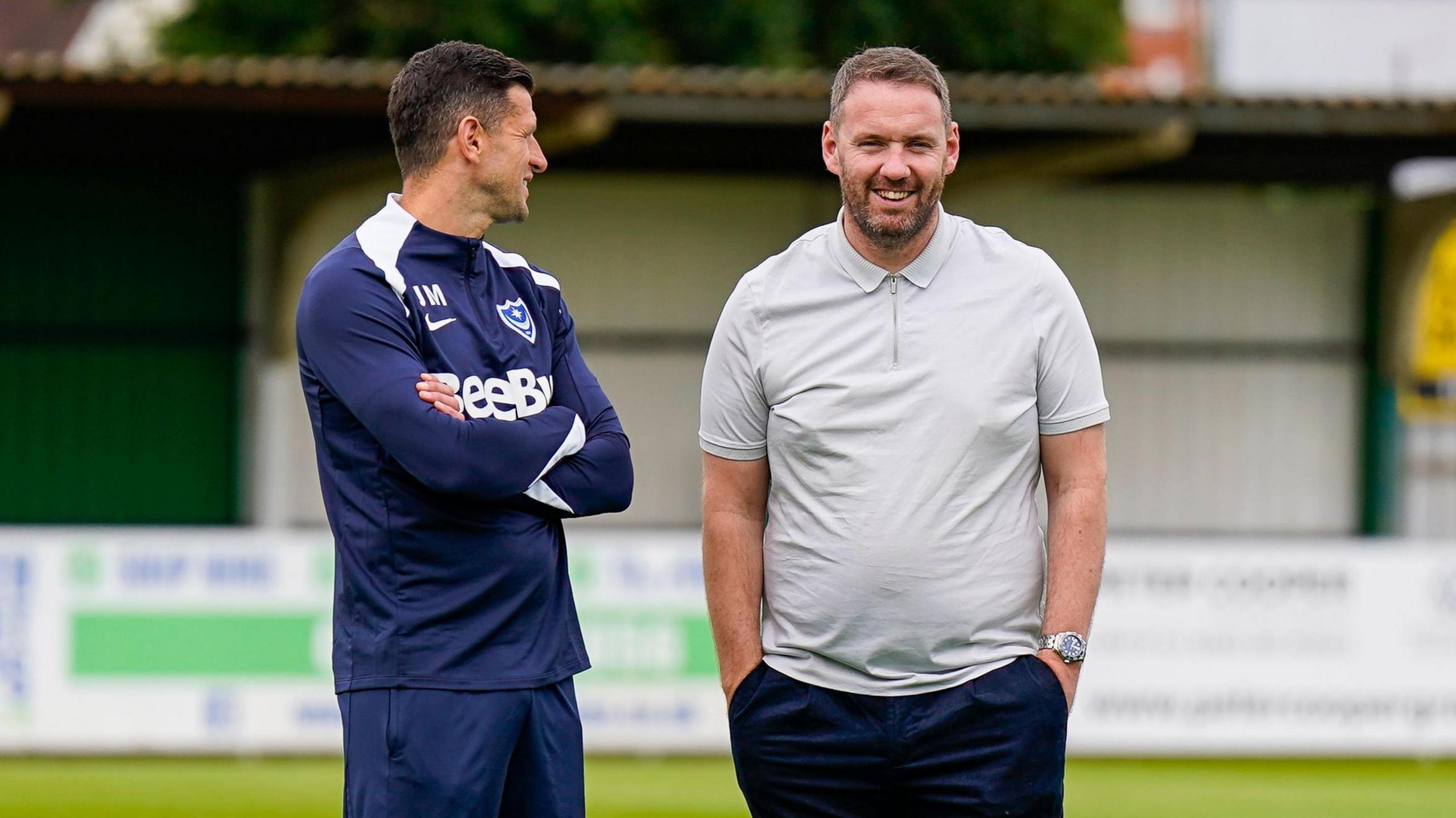 John Mousinho (left) speaking with Richard Hughes (right)