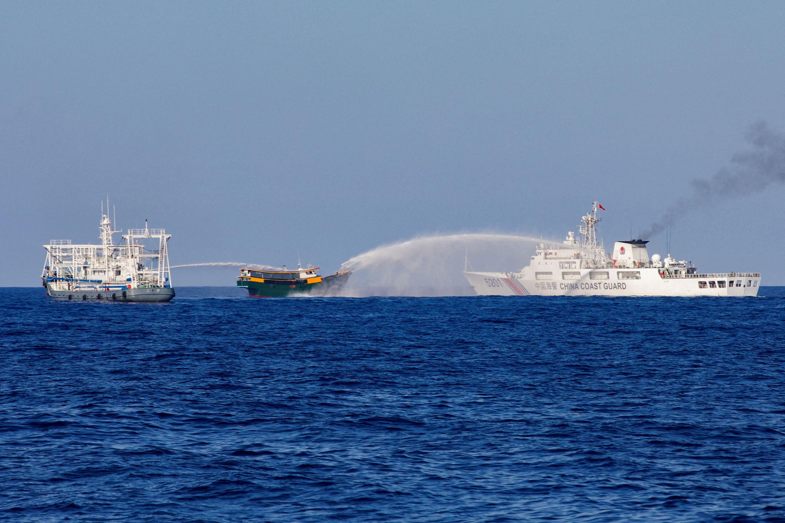 Chinese Coast Guard vessels fire water cannons towards a Philippine resupply vessel