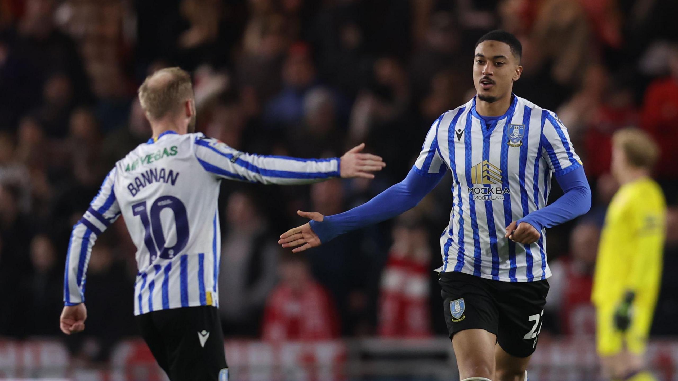 Yan Valery is congratulated for his goal by Sheff Wed captain Barry Bannan 