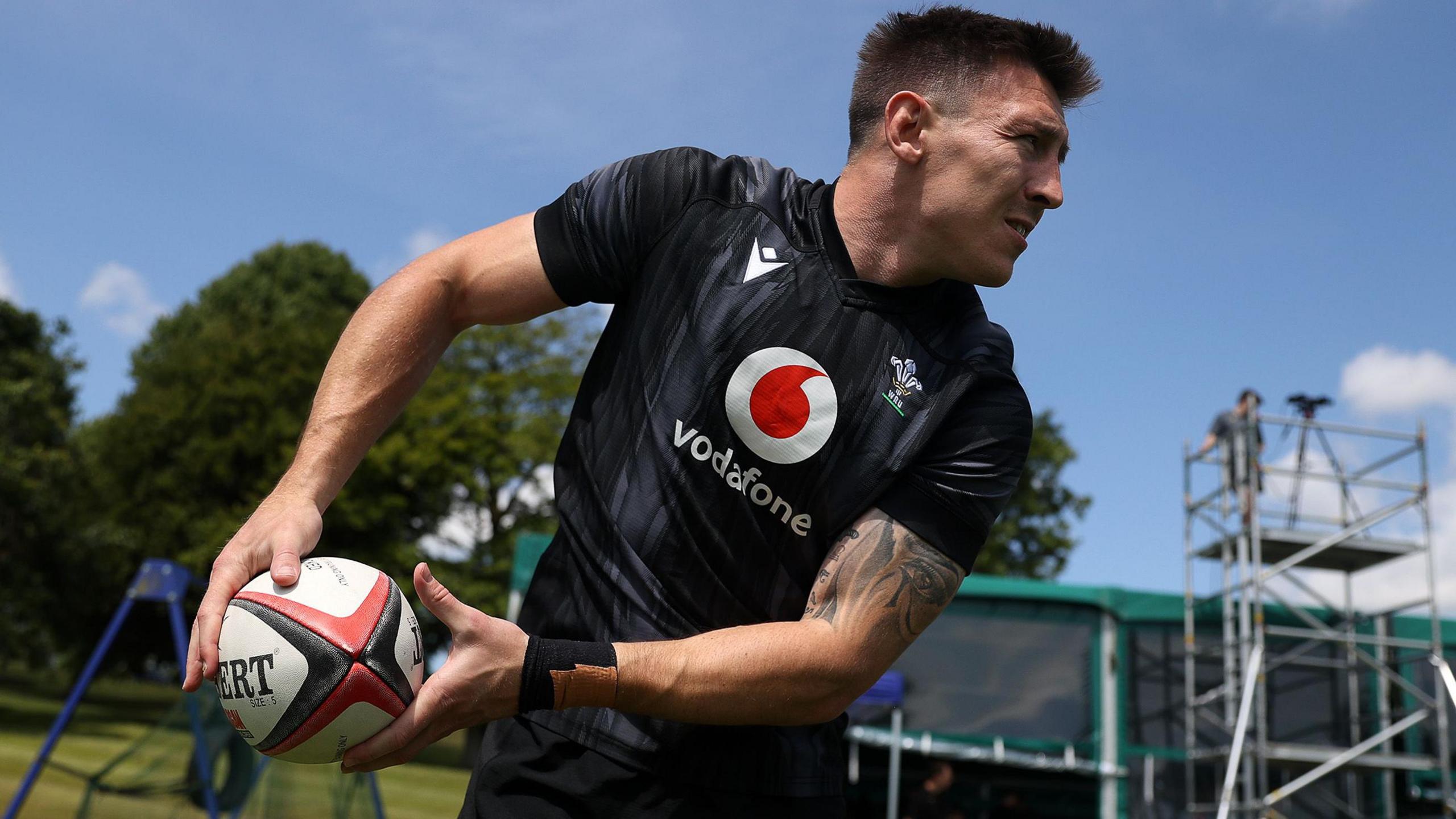 Josh Adams passes a rugby ball in training