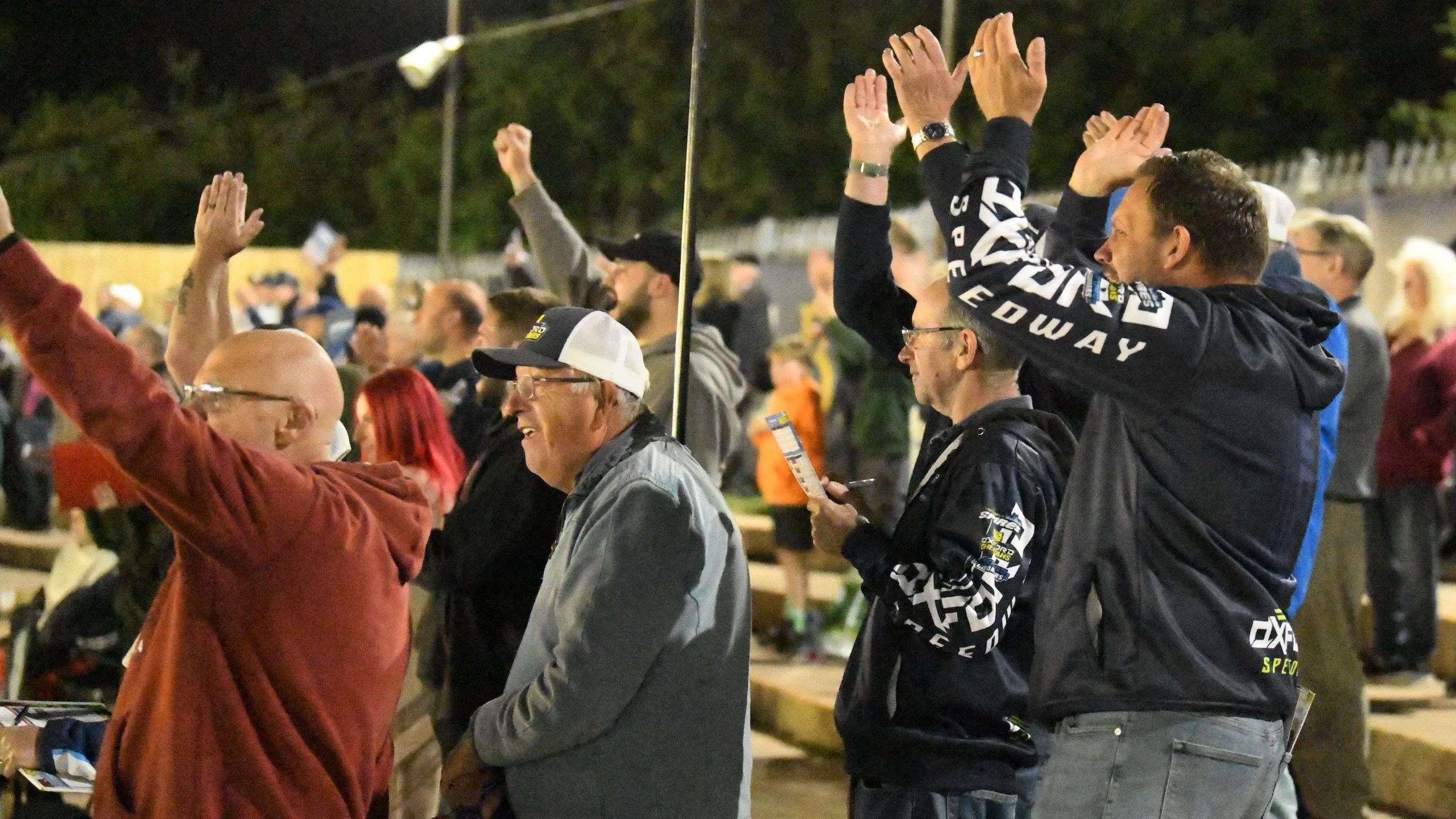 Fans of the Oxford Cheetahs clap and celebrate whilst watching a race.