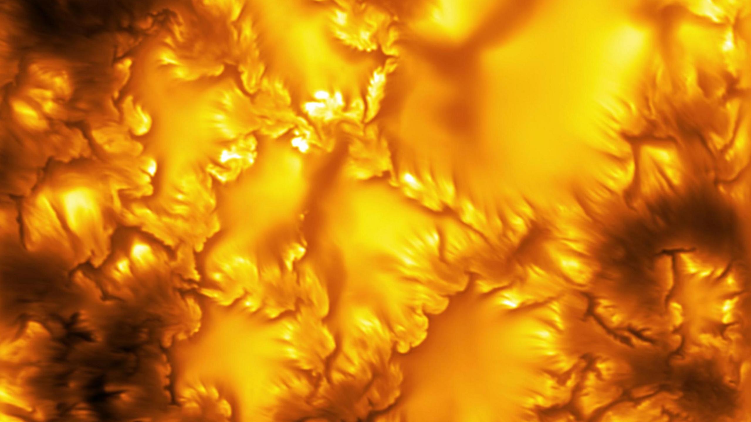 The image shows an extreme close-up of the surface of the Sun, captured by the world's most powerful solar telescope. It shows a fiery orange glow with patterns that look almost like etchings of leaves across the surface. These patterns are evidence of "swirls of instability" on the Sun's surface.