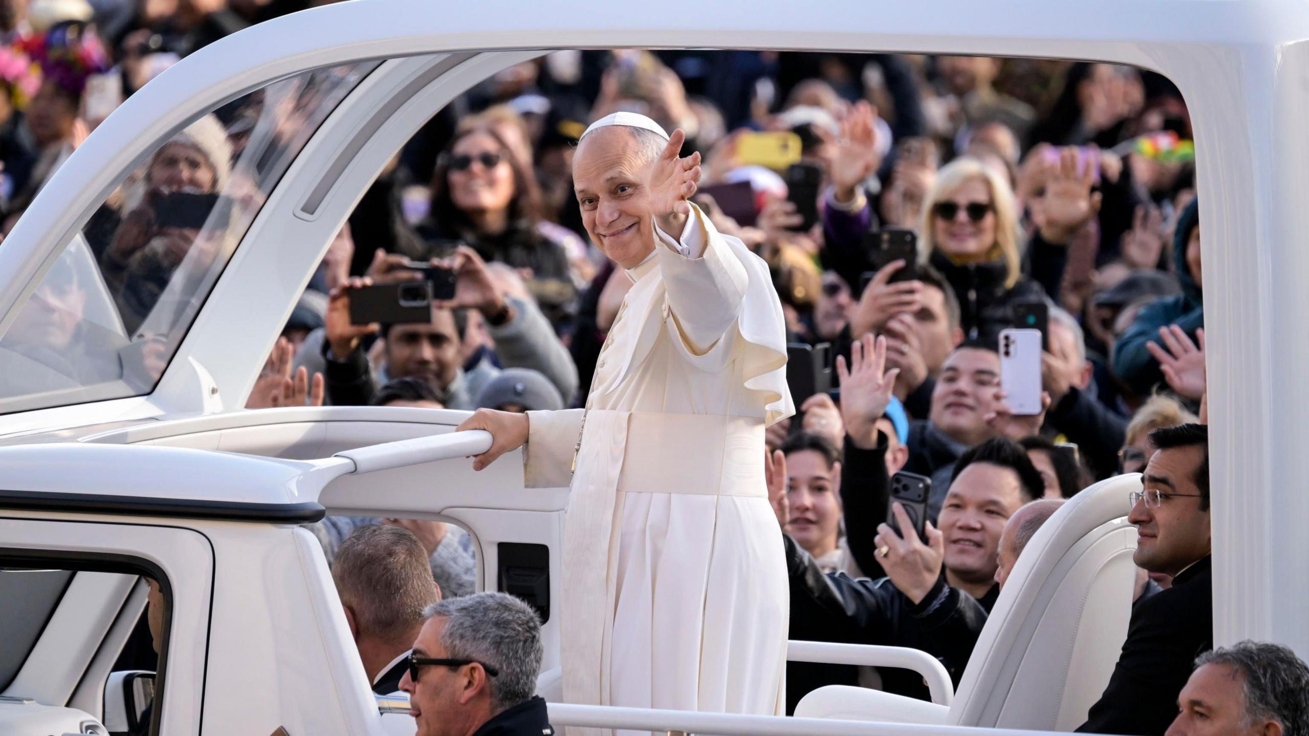 Pope Leo XIV in a papal white car, carting through a crowd at St Peter's Square, Vatican City 
