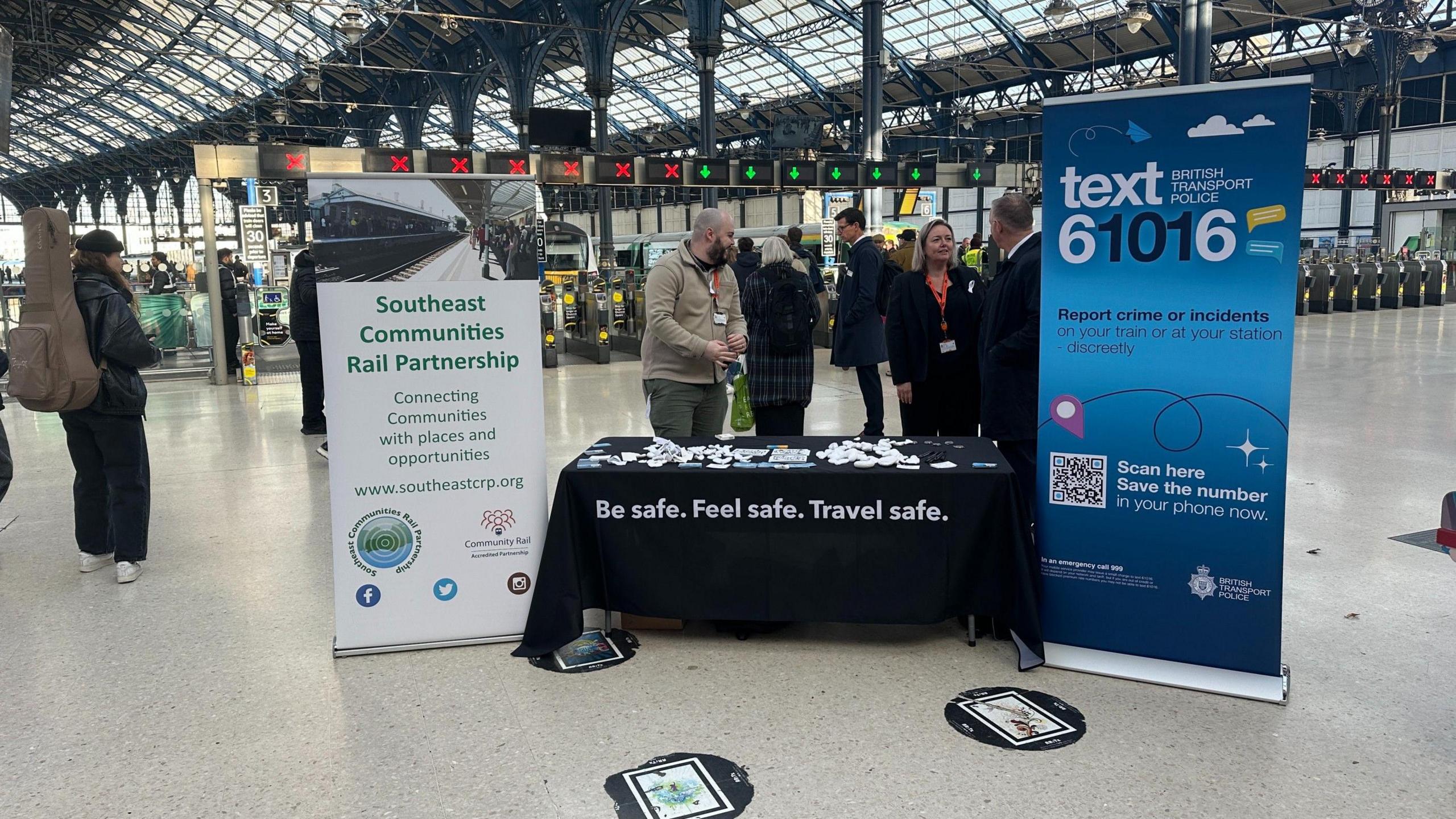A stand at Brighton station hands out promotional material to rail travellers.