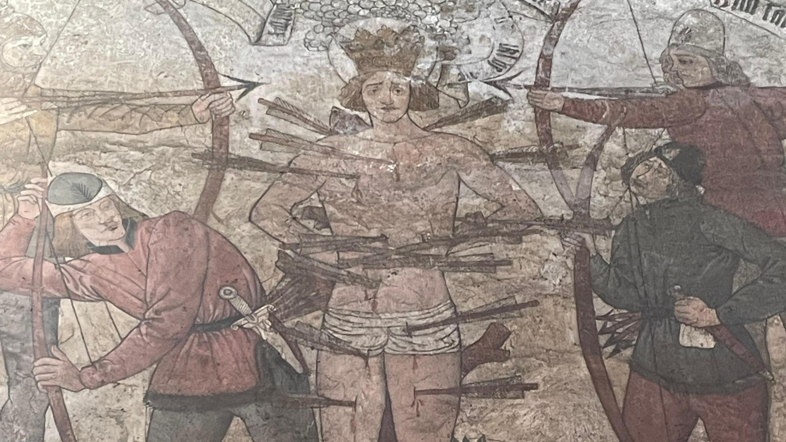 Wall art displaying a man wearing a crown with arrows protruding from his naked torso with archers firing arrows on either side of him.  