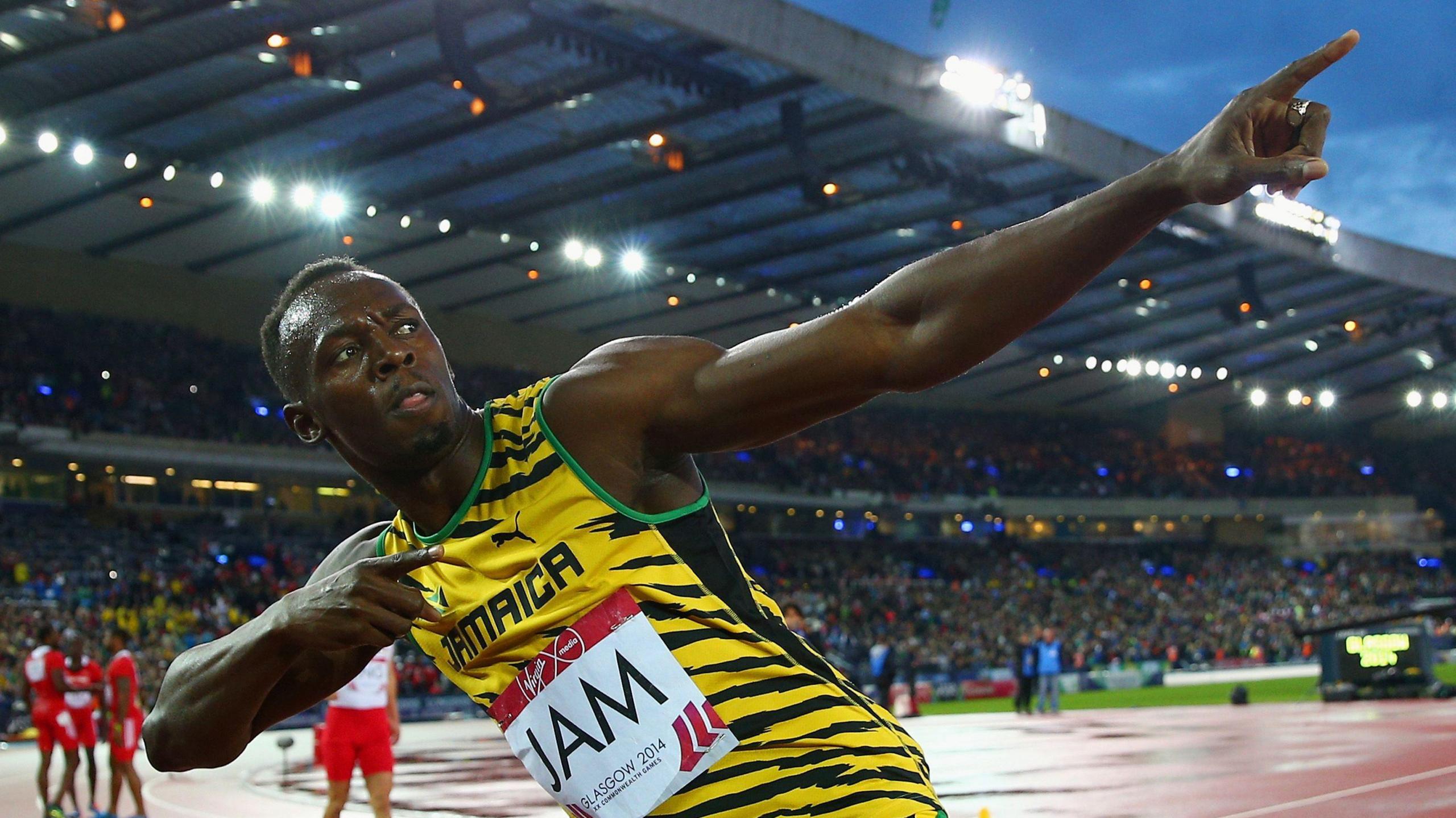 Usain Bolt strikes his famous lightening bolt pose after winning gold in the 4x100m relay at Hampden.