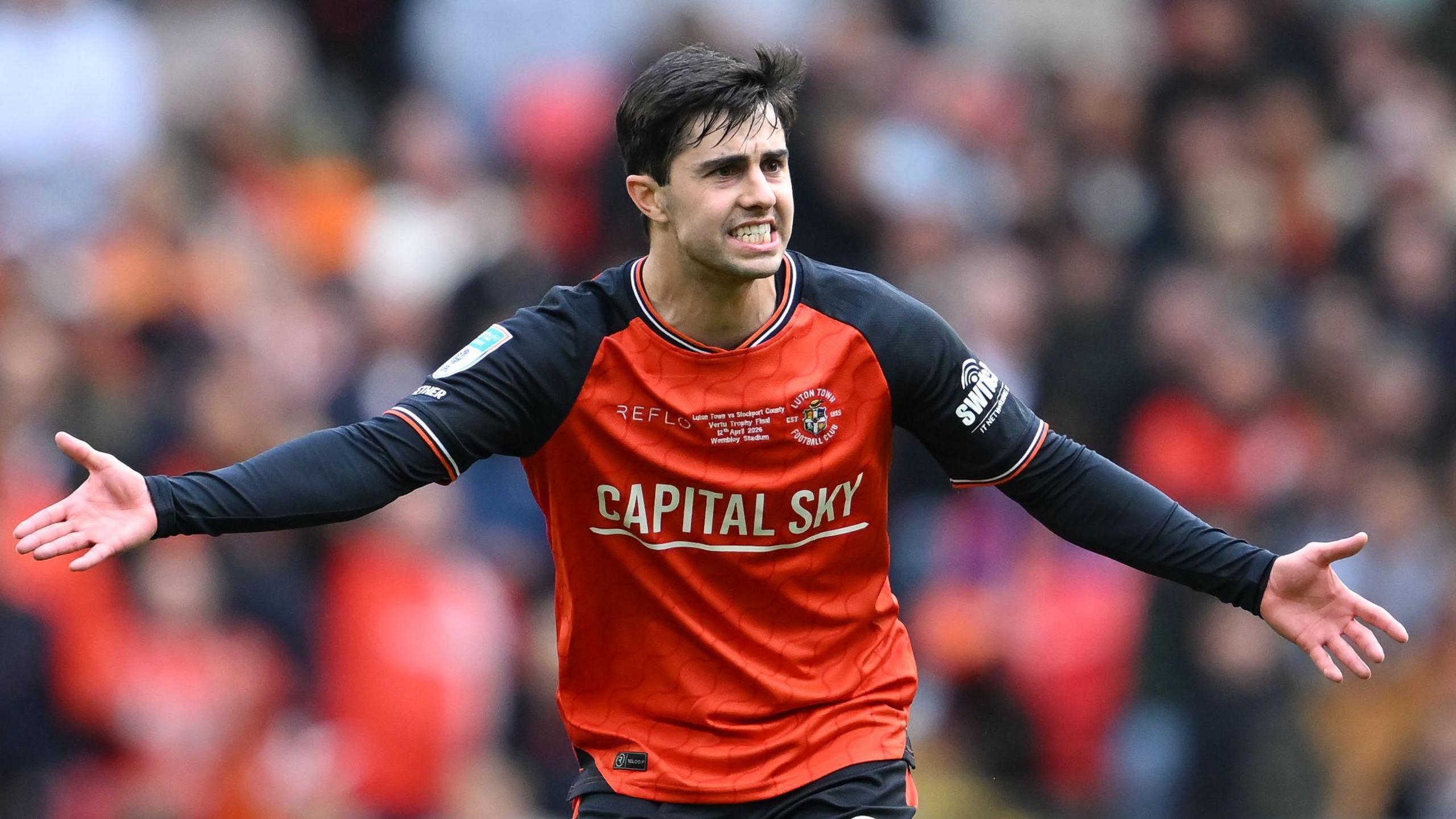 Luton Town midfielder Liam Walsh gesticulating with his arms out wide