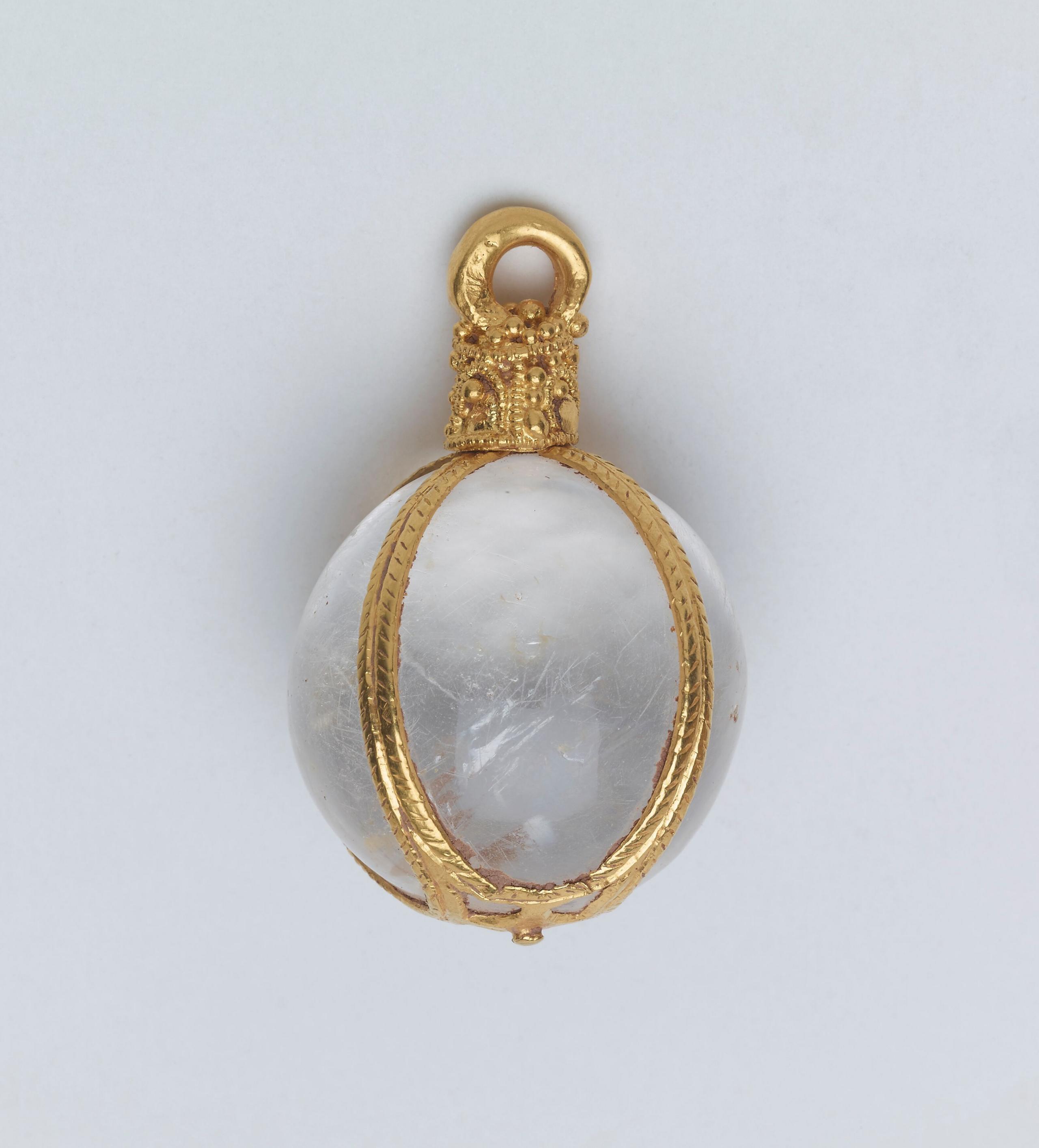 A crystal sphere, surrounded by a finely crafted gold cage structure.  It has a crown at the top, and a loop allowing it to be hung from a chain.