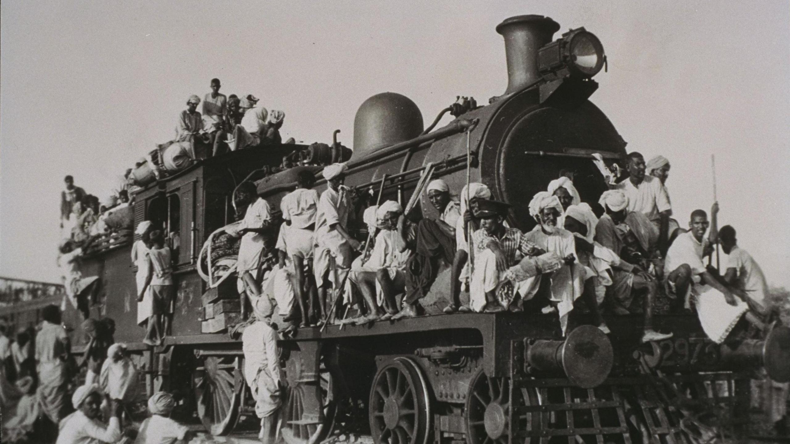 Muslim refugees fleeing India for Pakistan crowd train engine, 1947. Gelatin silver photograph shows Muslim refugees fleeing India for Pakistan. They are crowding the train engine in their panic and desperation to leave the country. (Photo by Daily Herald Archive/National Science & Media Museum/SSPL via Getty Images)
