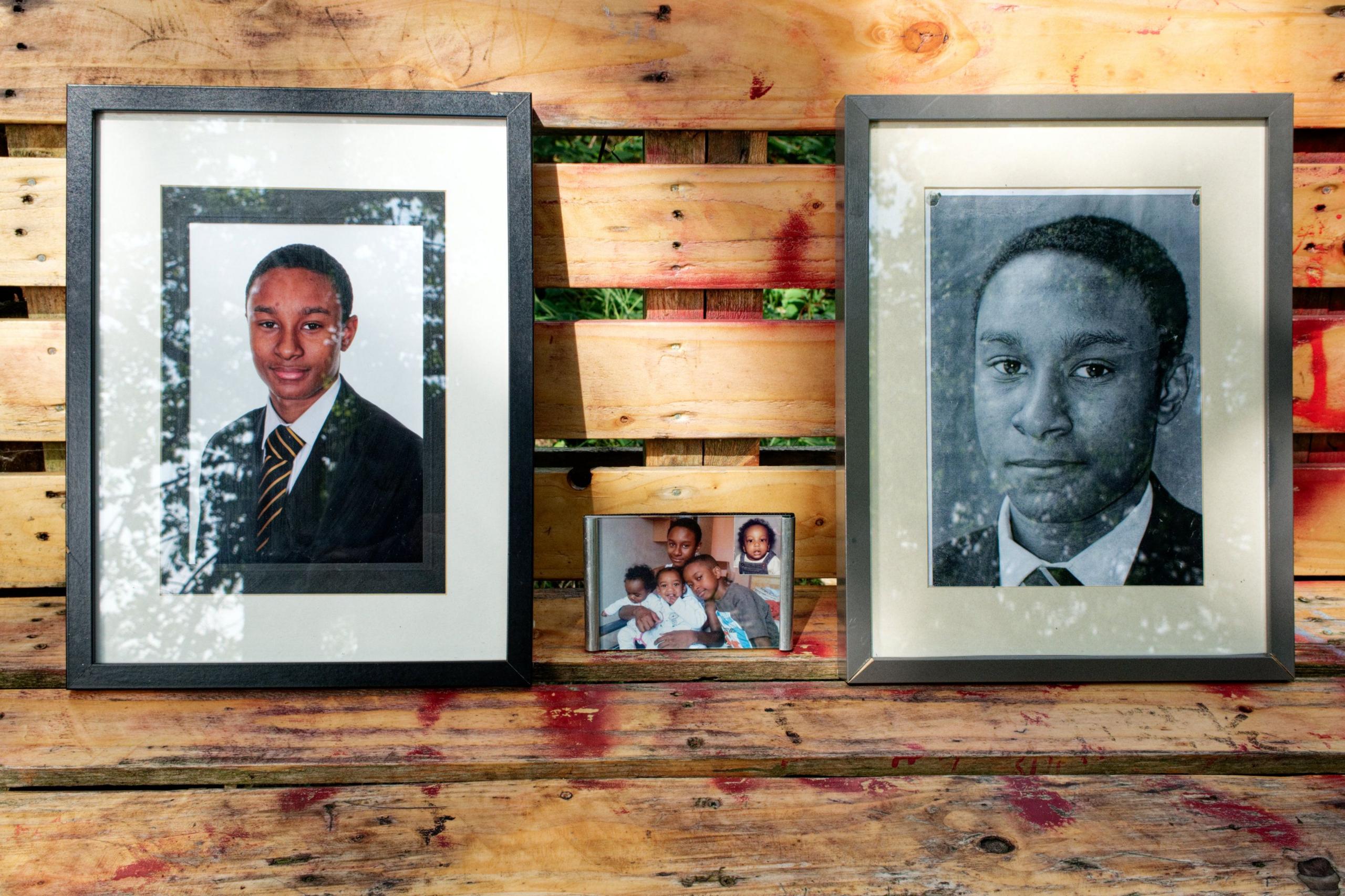 Two framed pictures of Jovanni Peddie, and one of him and his family 