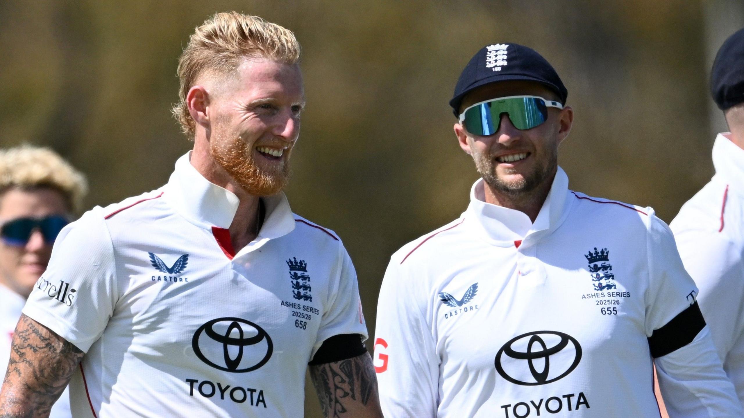 Ben Stokes (left) has number 658 on his jersey and Joe Root (right) has number 655 on his jersey. He also has 150 under the crest on his England cap.
