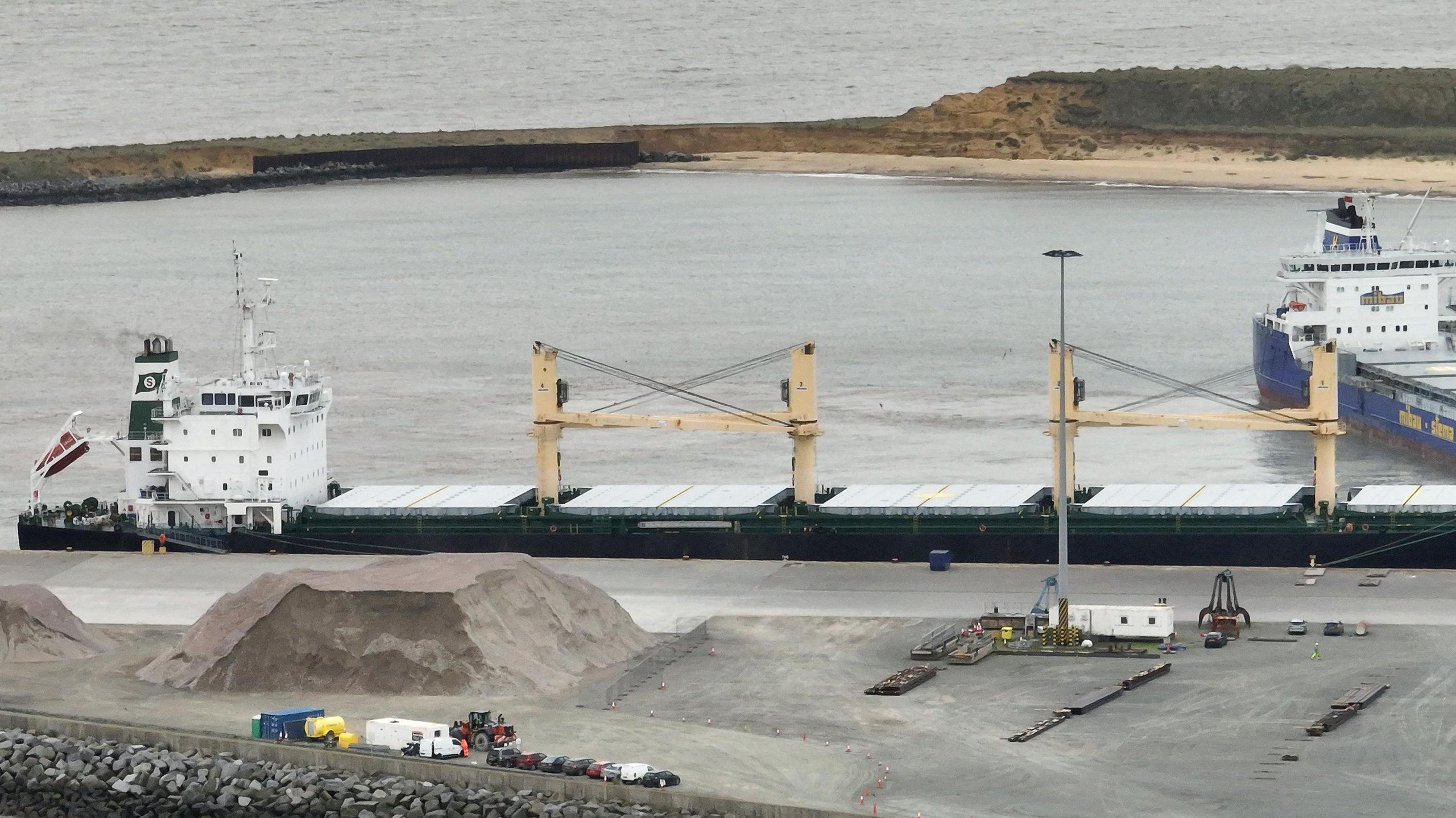 The MV Ruby ship docked at Great Yarmouth port with another vessel at right angles and water in the background